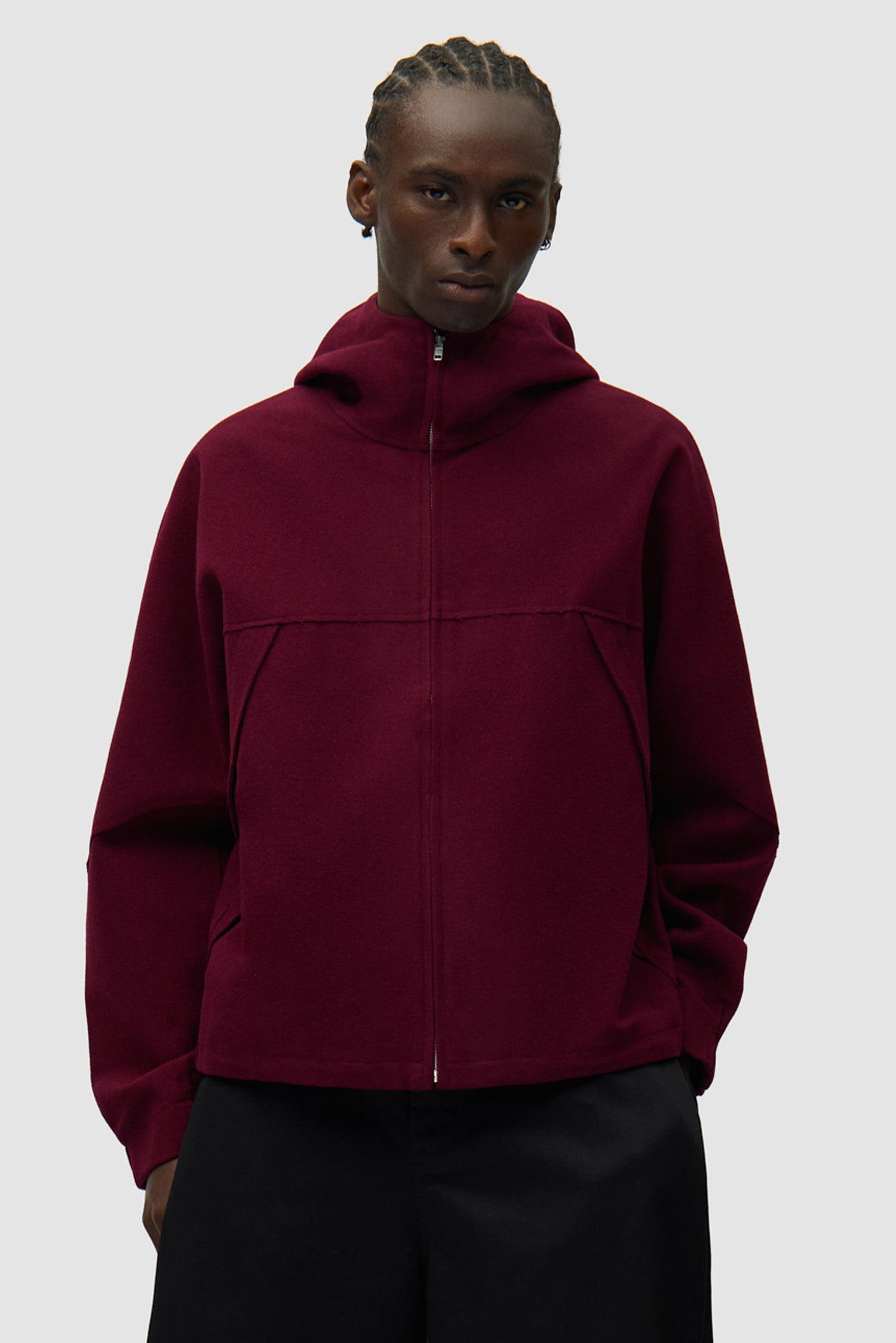 Veste technique en laine bordeaux portée par un mannequin, vue de face en demi-corps