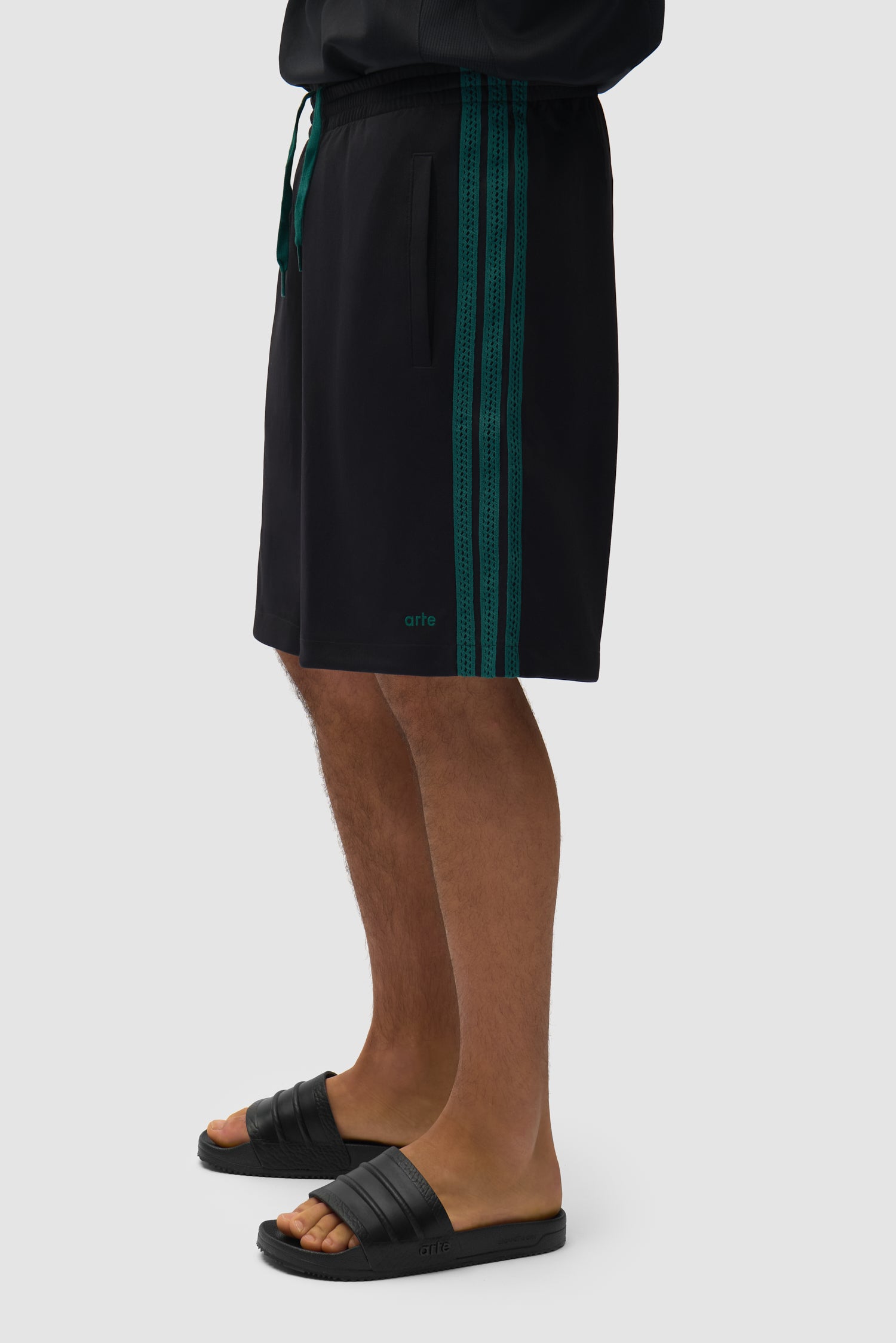 Arte pour adidas Short noir porté par un mannequin, vue de profil à mi-corps