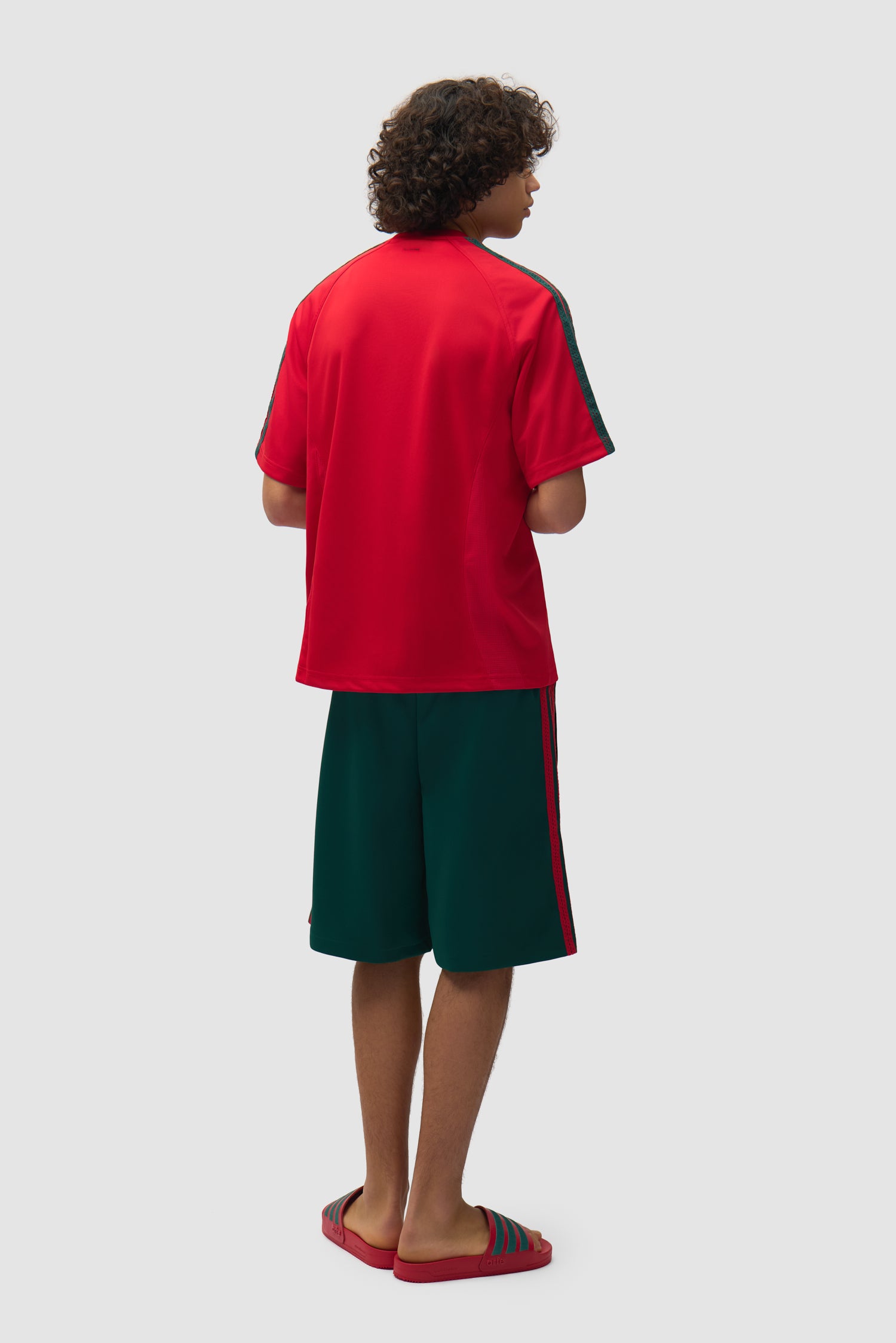 Short Arte pour adidas vert universitaire porté par un mannequin, vue arrière intégrale