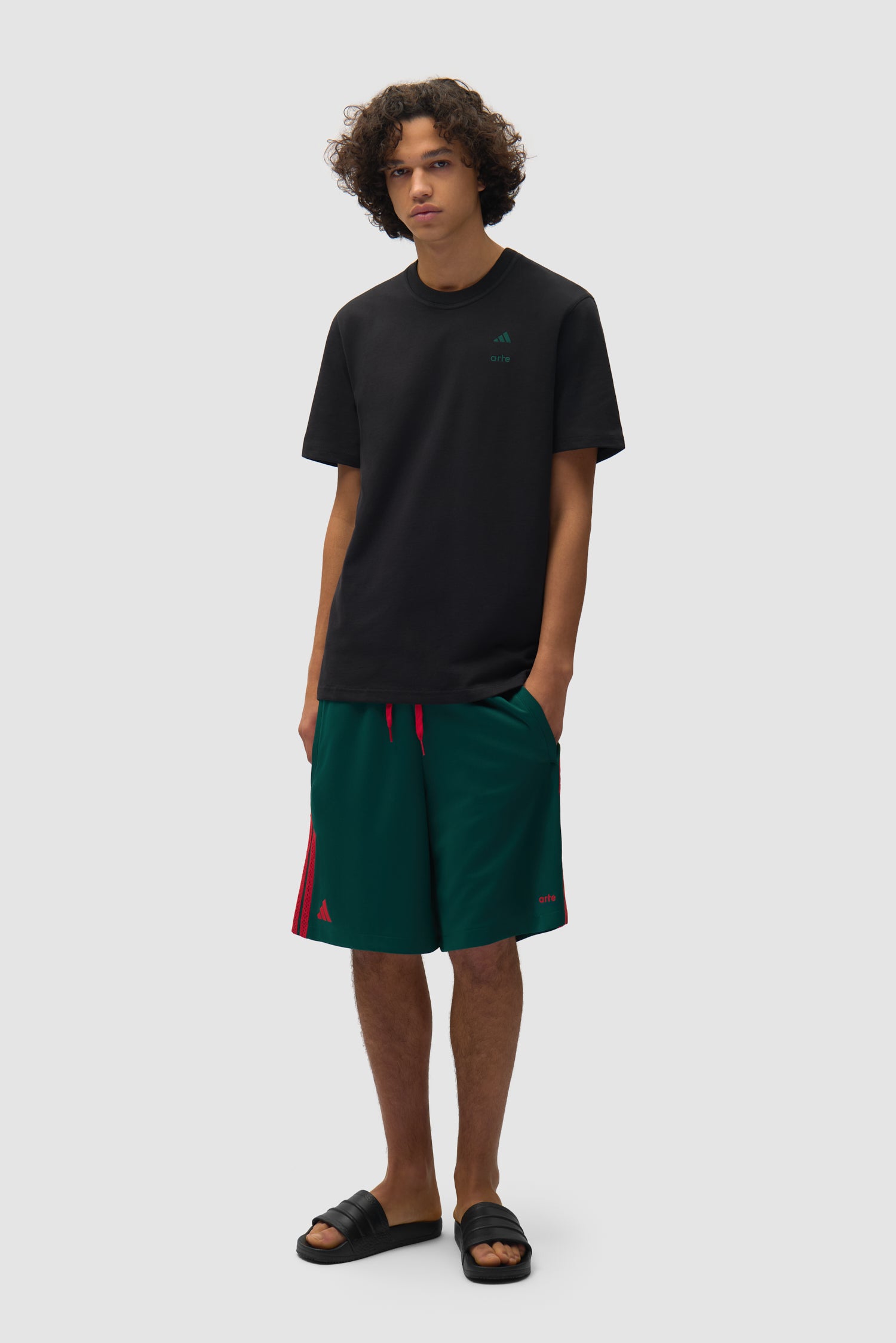 T-shirt Arte pour adidas noir porté par un mannequin, vue de profil en pied