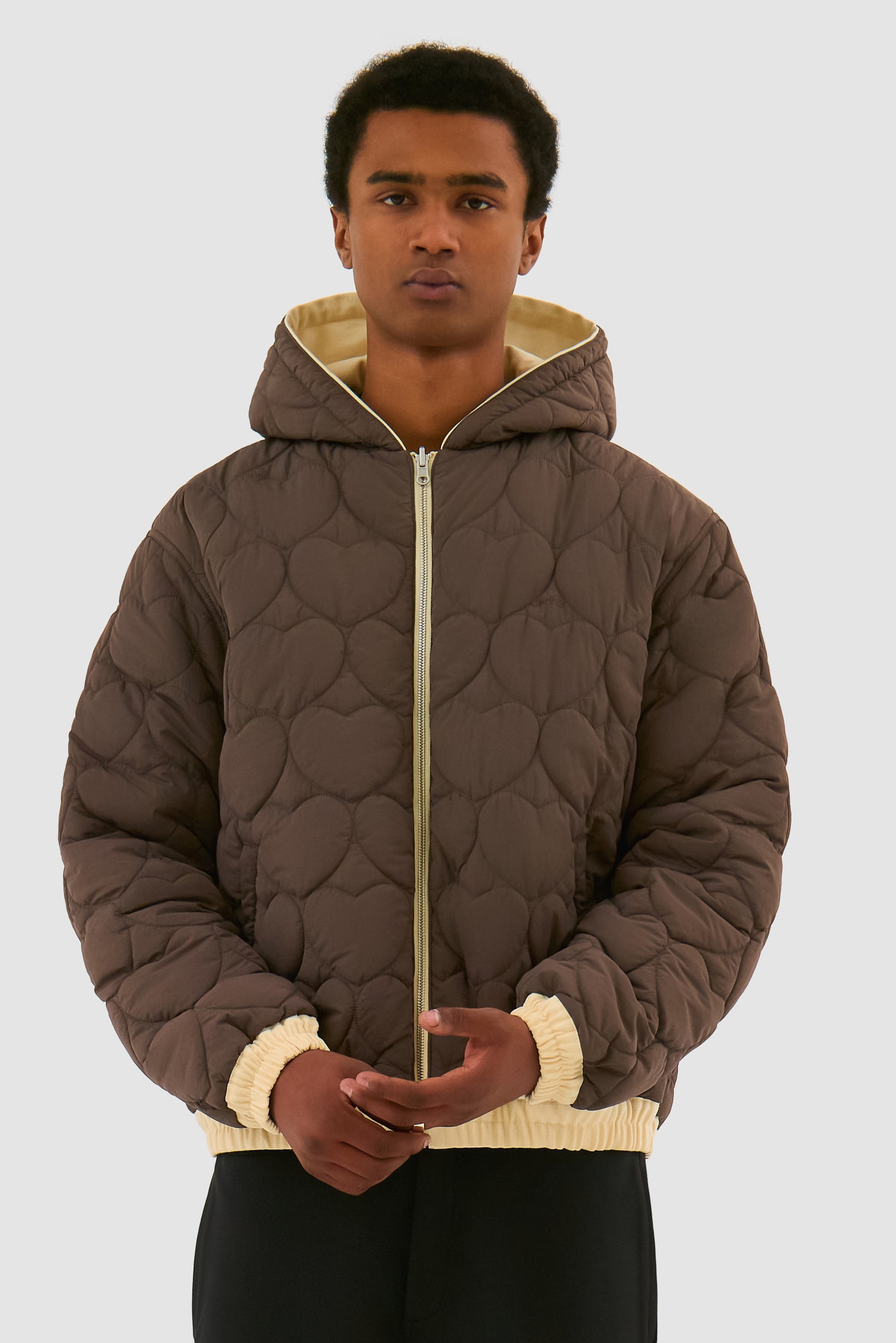 Reversible Hooded Jacket in Cream worn by a model, half-body detailed view