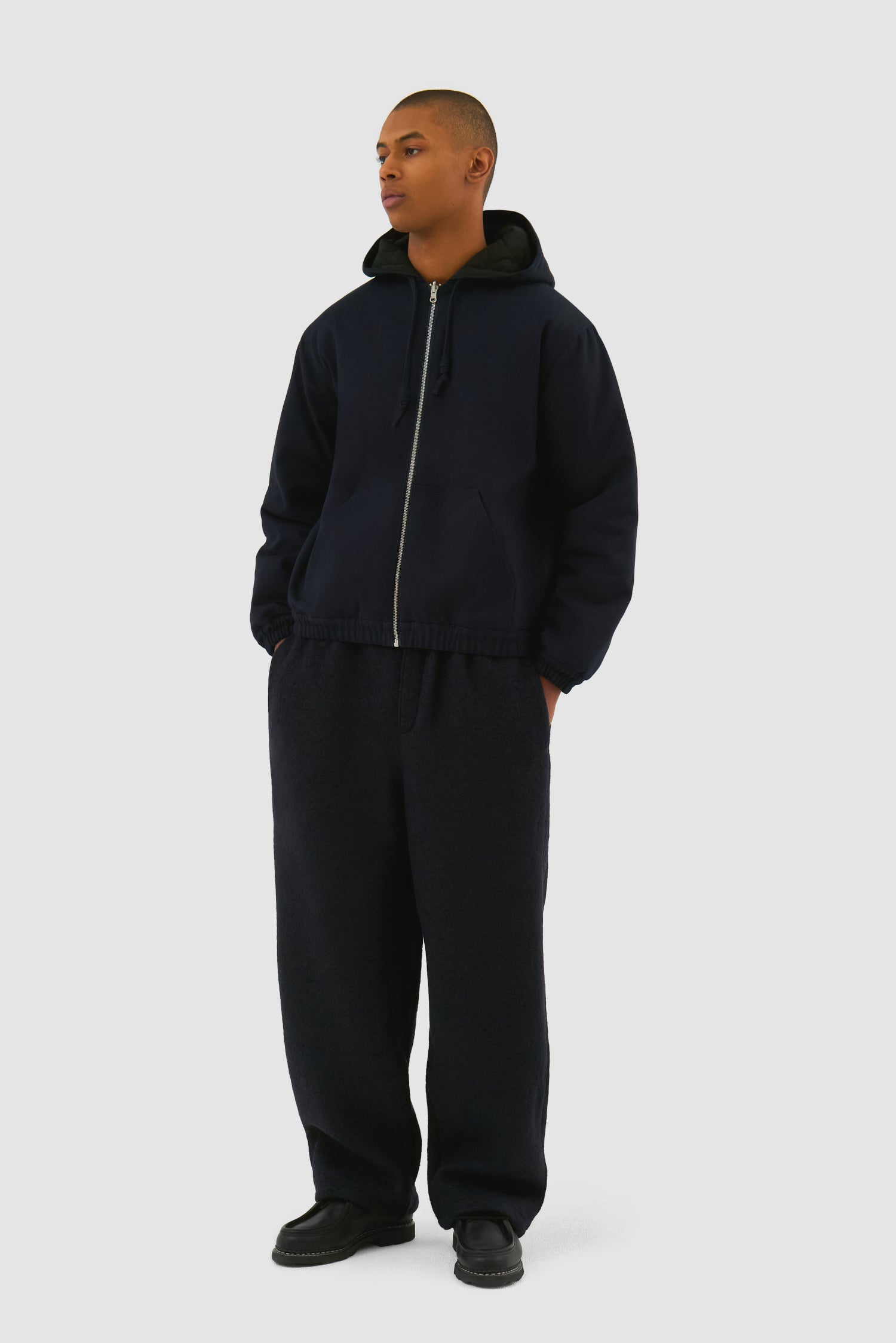 Reversible Hooded Jacket in Navy worn by a model, full-body side view