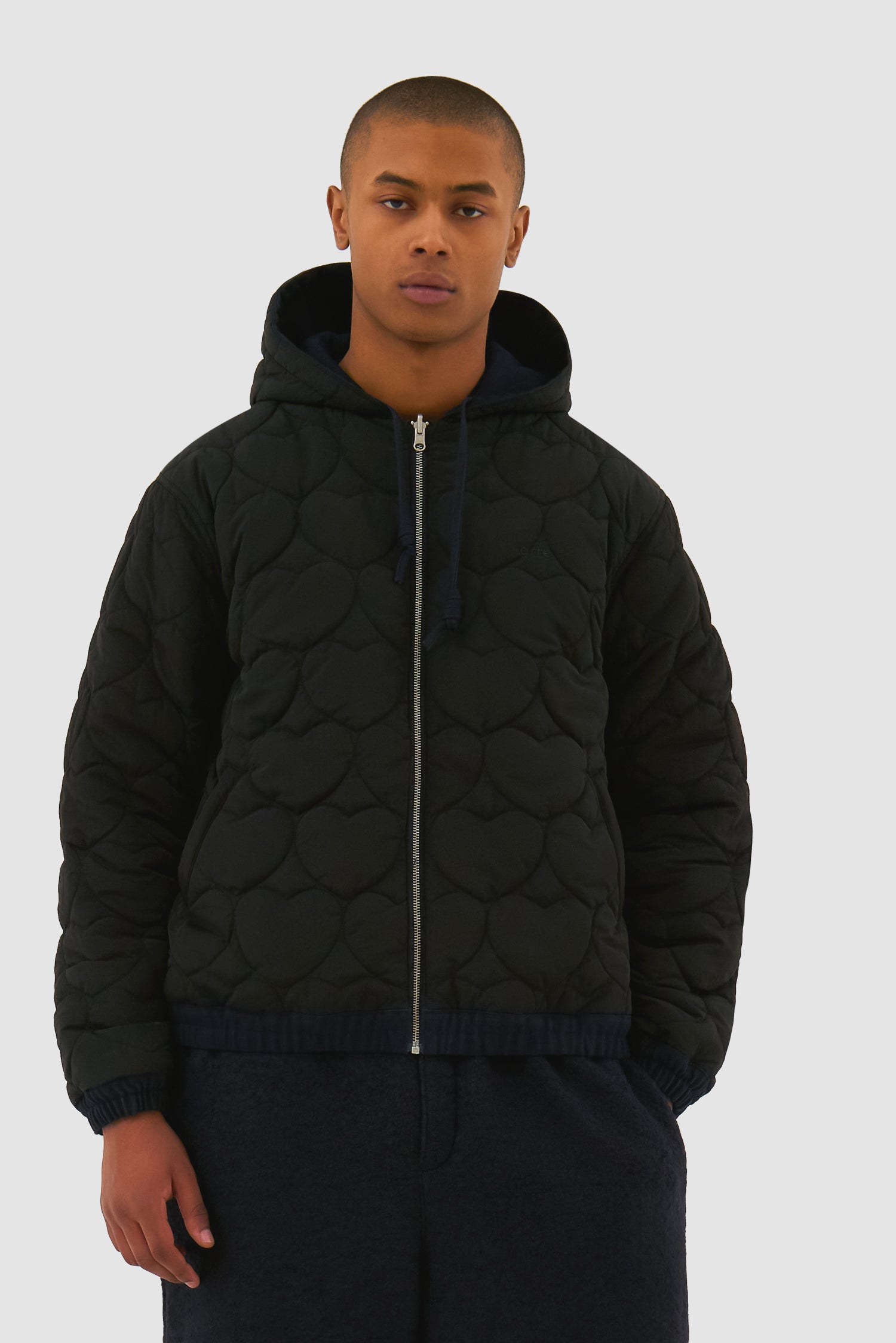 Reversible Hooded Jacket in Navy worn by a model, half-body detailed view