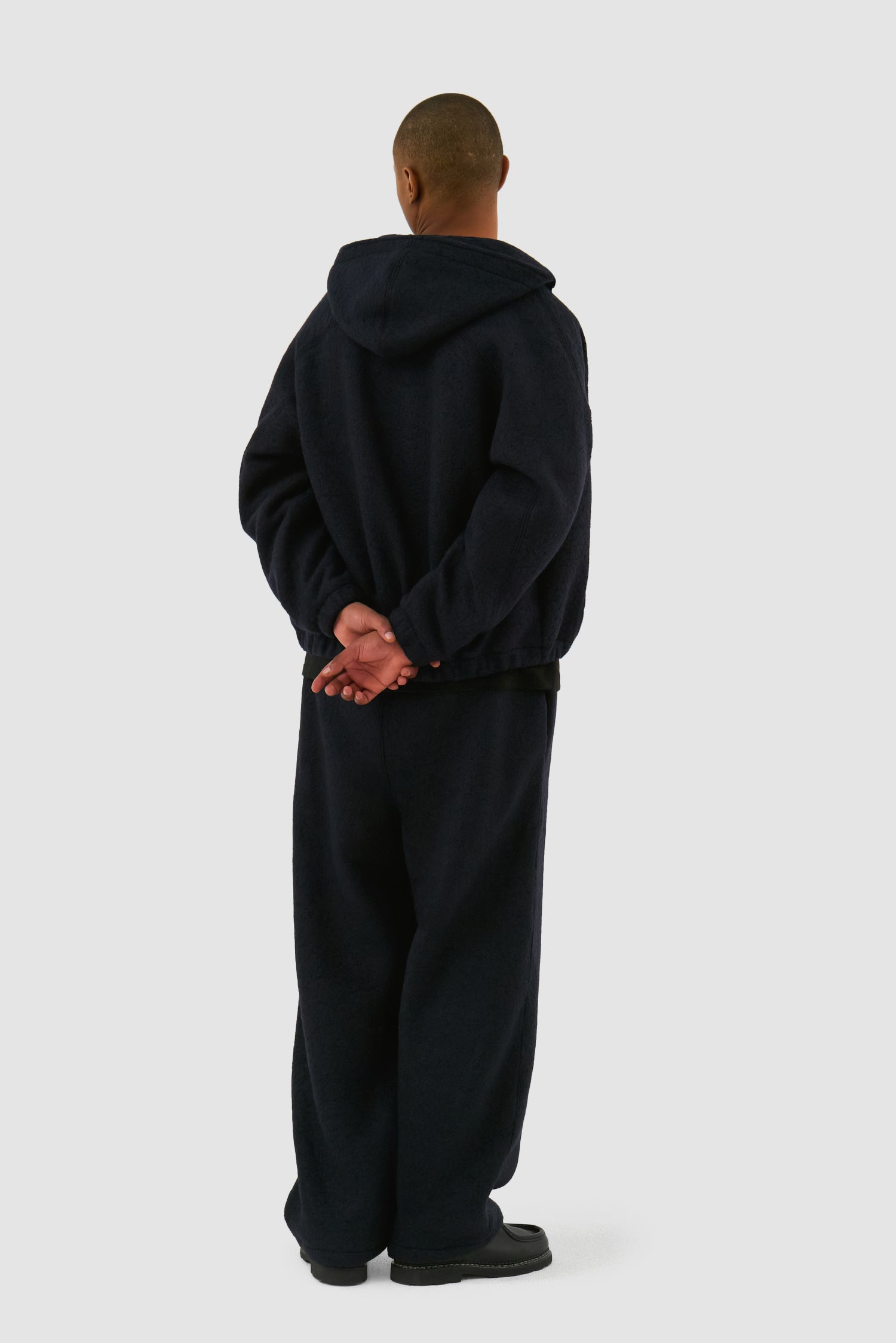 Boiled Wool Pants in Navy worn by a model, full-body front view