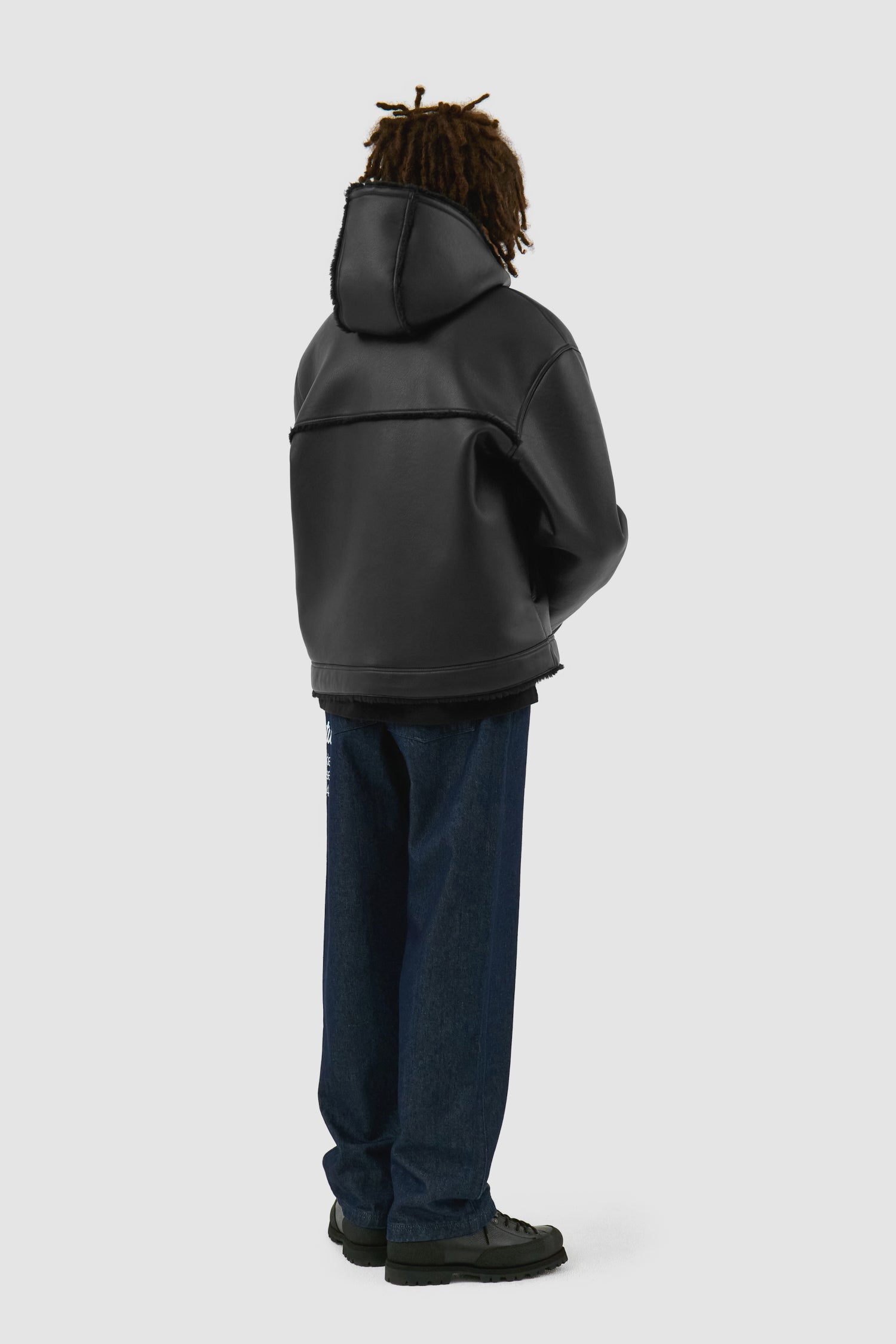 Shearling Jacket in Black worn by a model, full-body back view