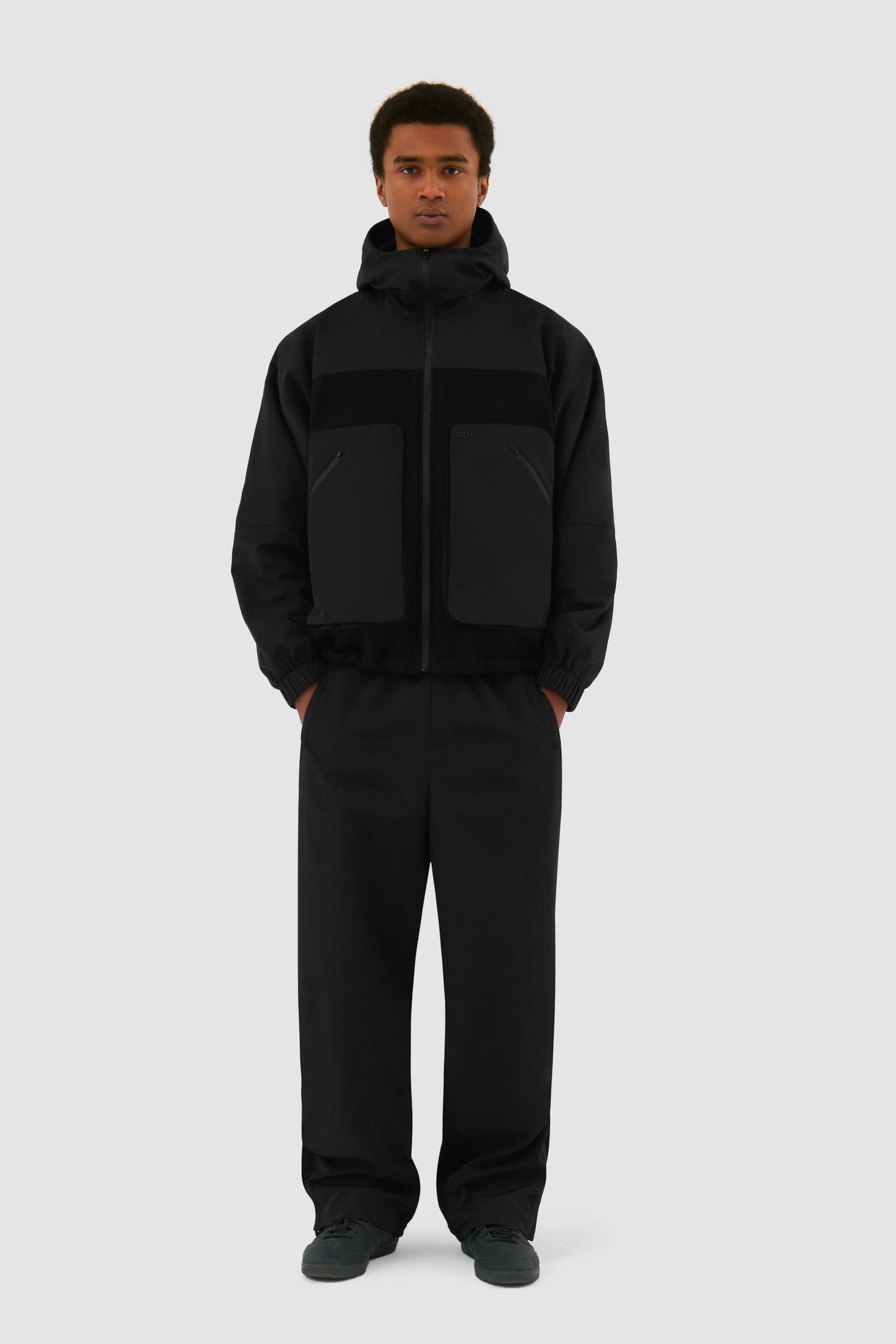 Wool Technical Jacket in Black worn by a model, full-body front view