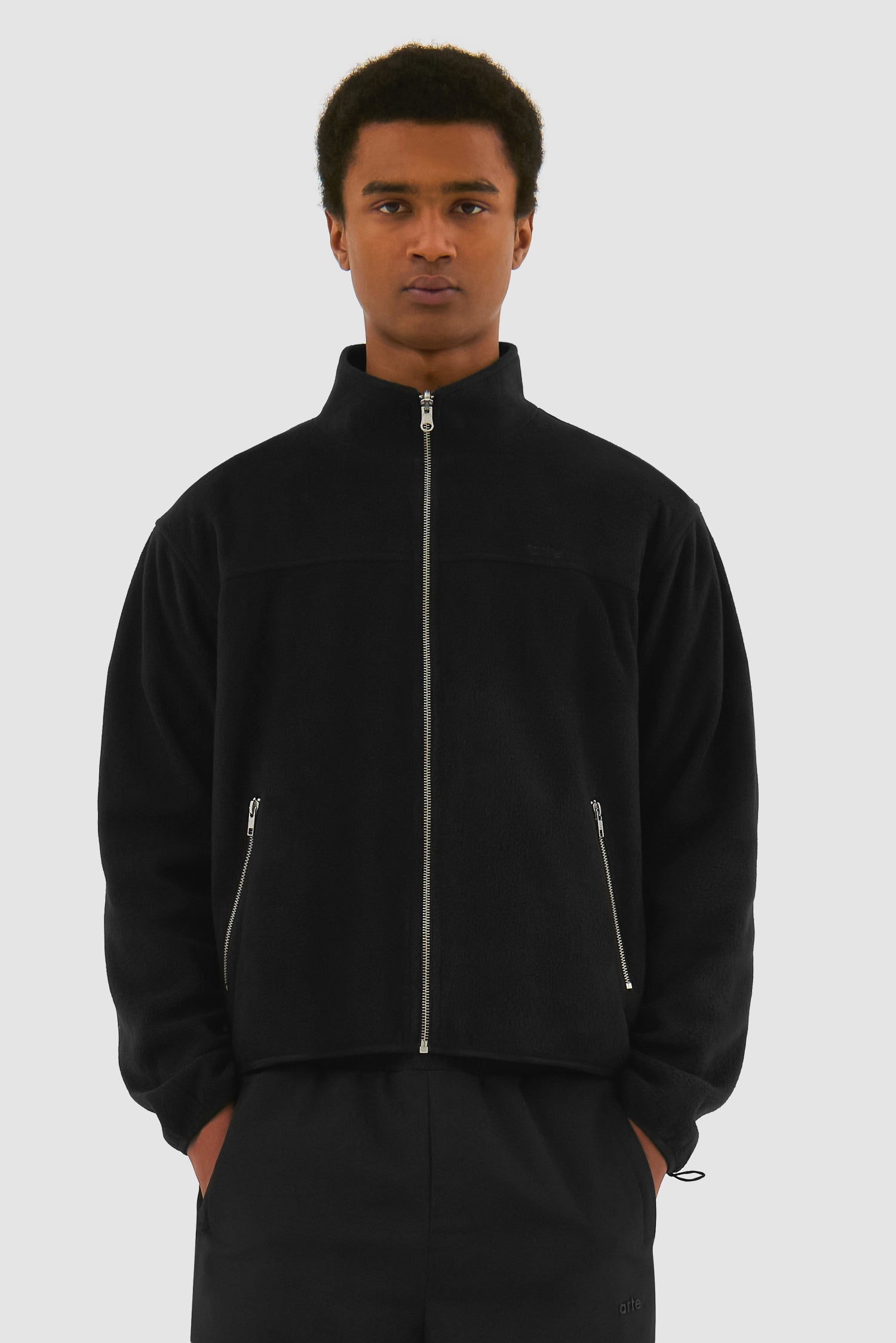 Wool Technical Jacket in Black worn by a model, half-body front view showing the inside layer