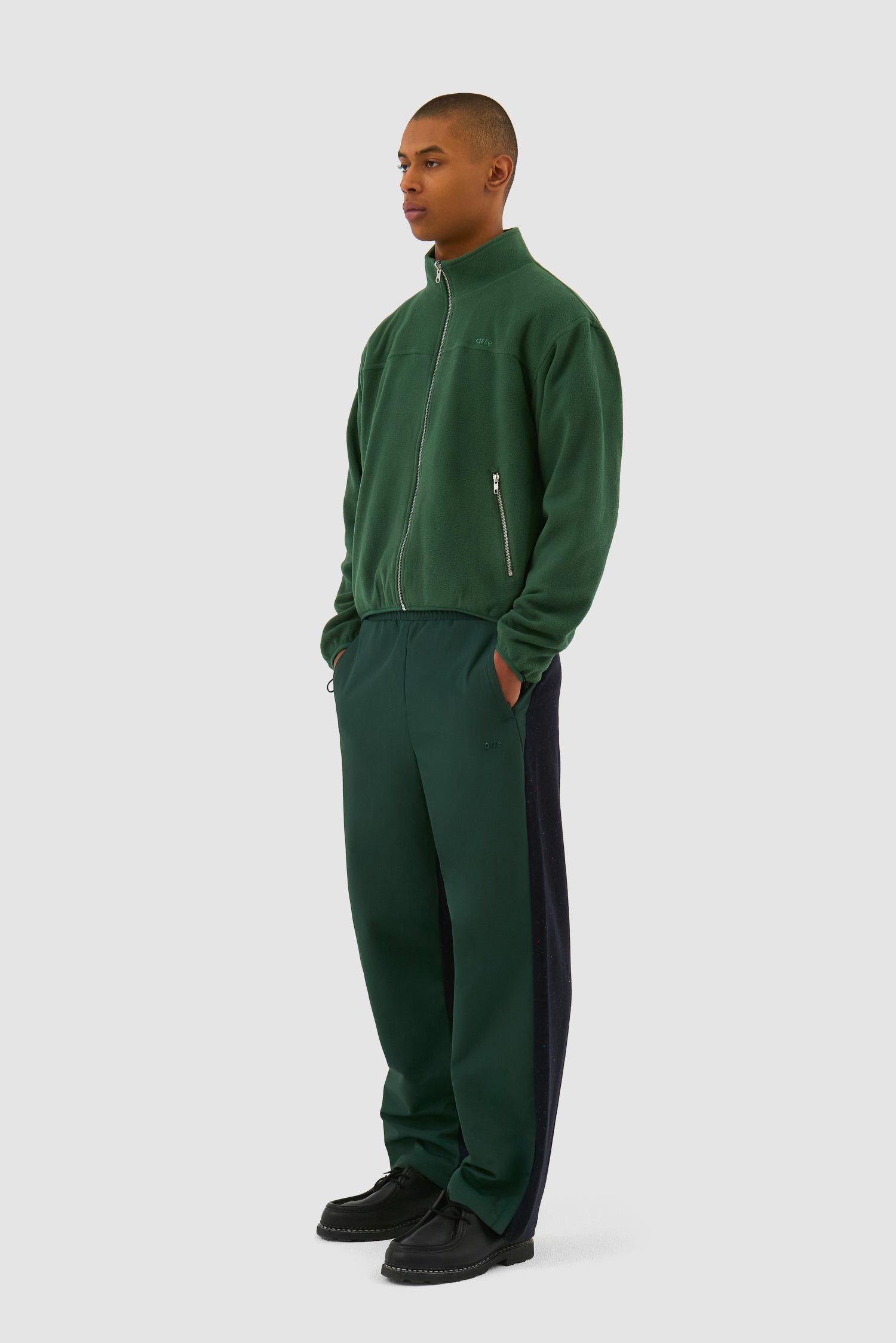 Wool Technical Jacket in Green worn by a model, full-body side view showing the inside layer