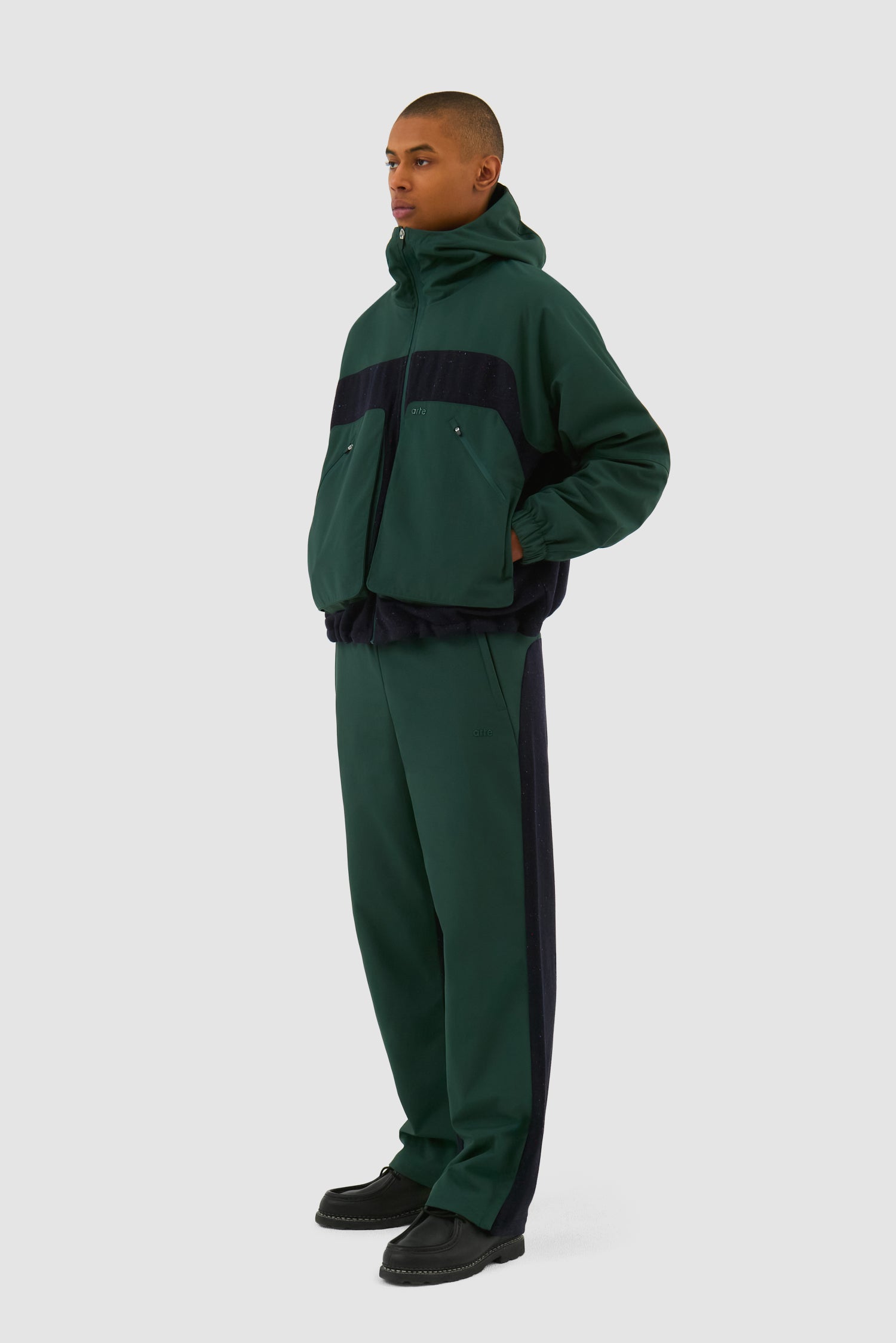 Wool Technical Jacket in Green worn by a model, full-body side view