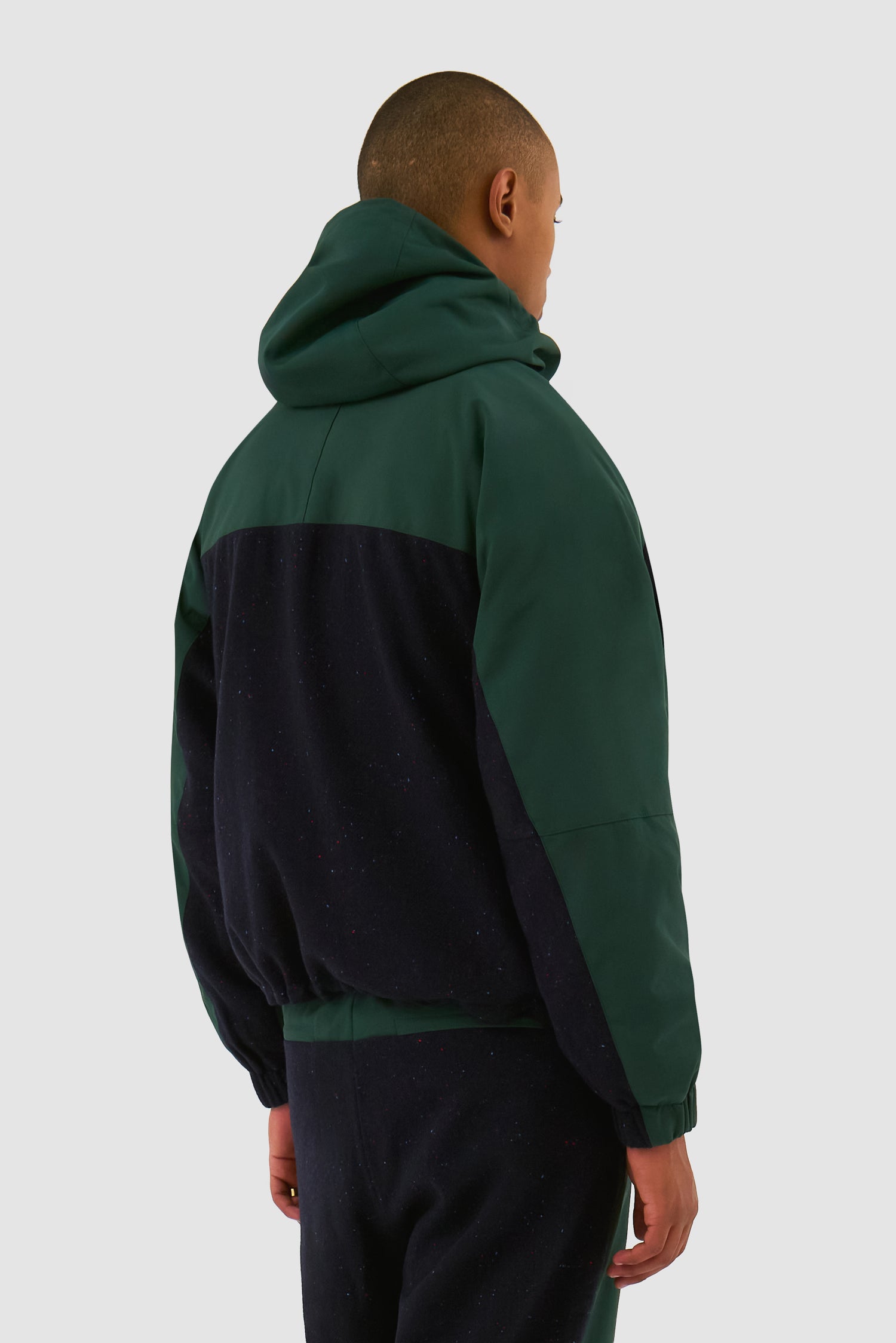 Wool Technical Jacket in Green worn by a model, half-body back view