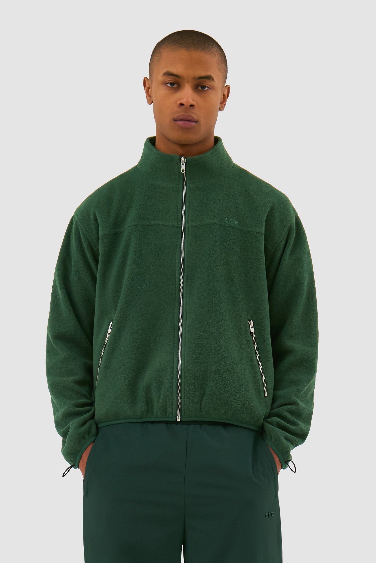 Wool Technical Jacket in Green worn by a model, half-body front view showing the inside layer