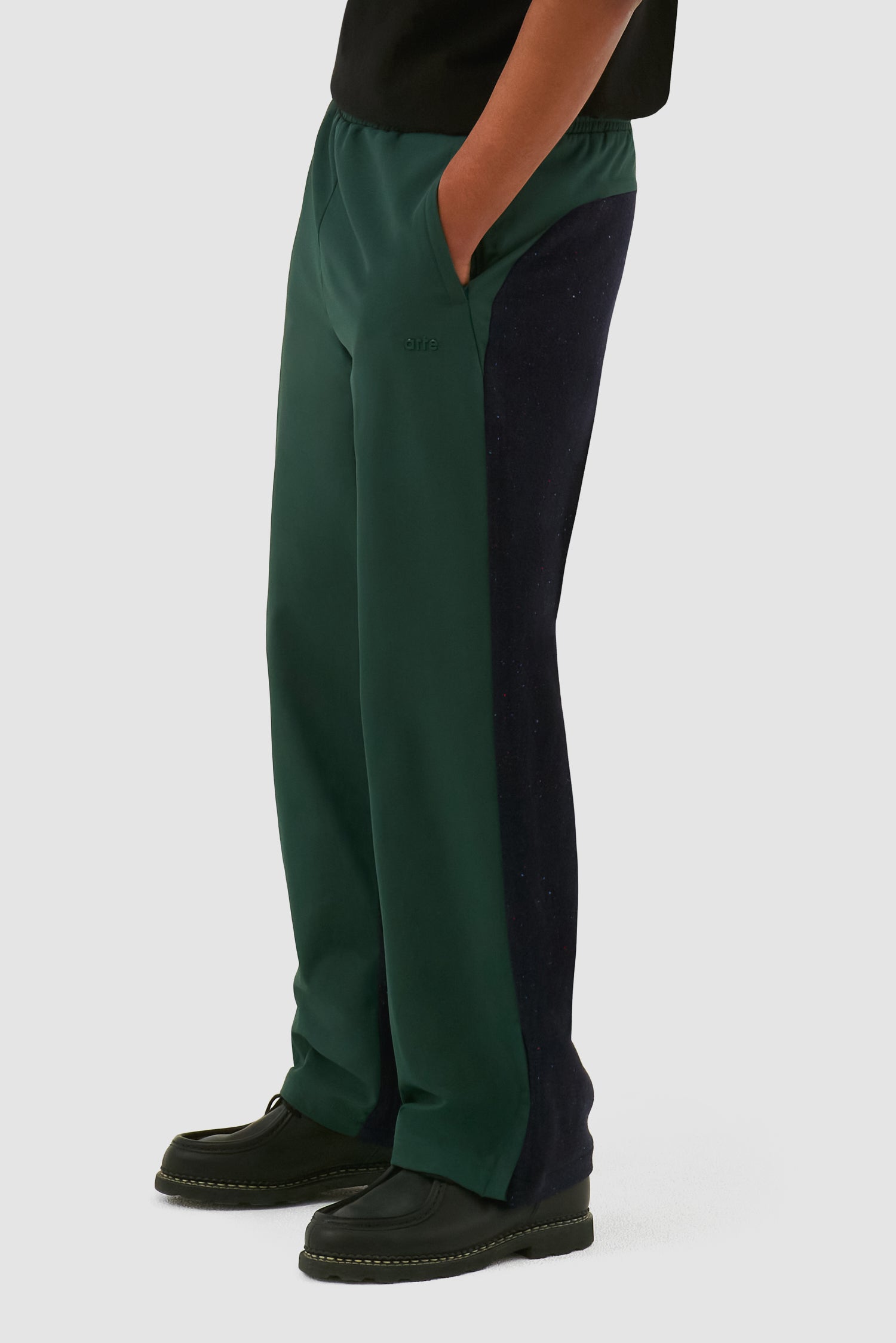 Wool Technical Pants in Green worn by a model, full-body back view