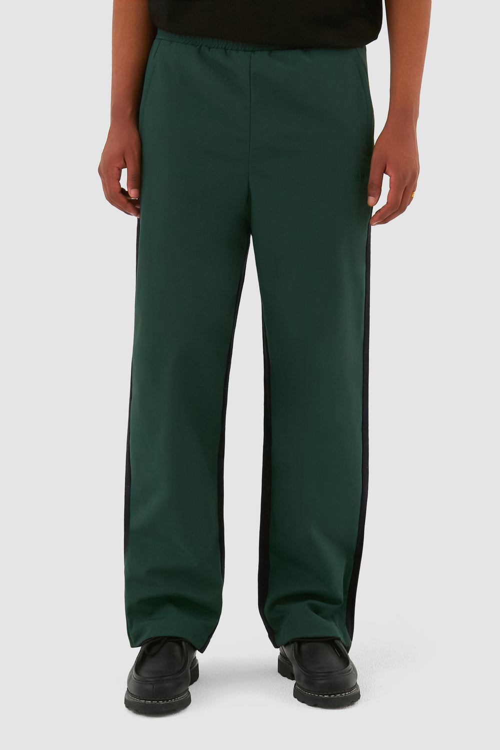 Wool Technical Pants in Green worn by a model, half-body front view