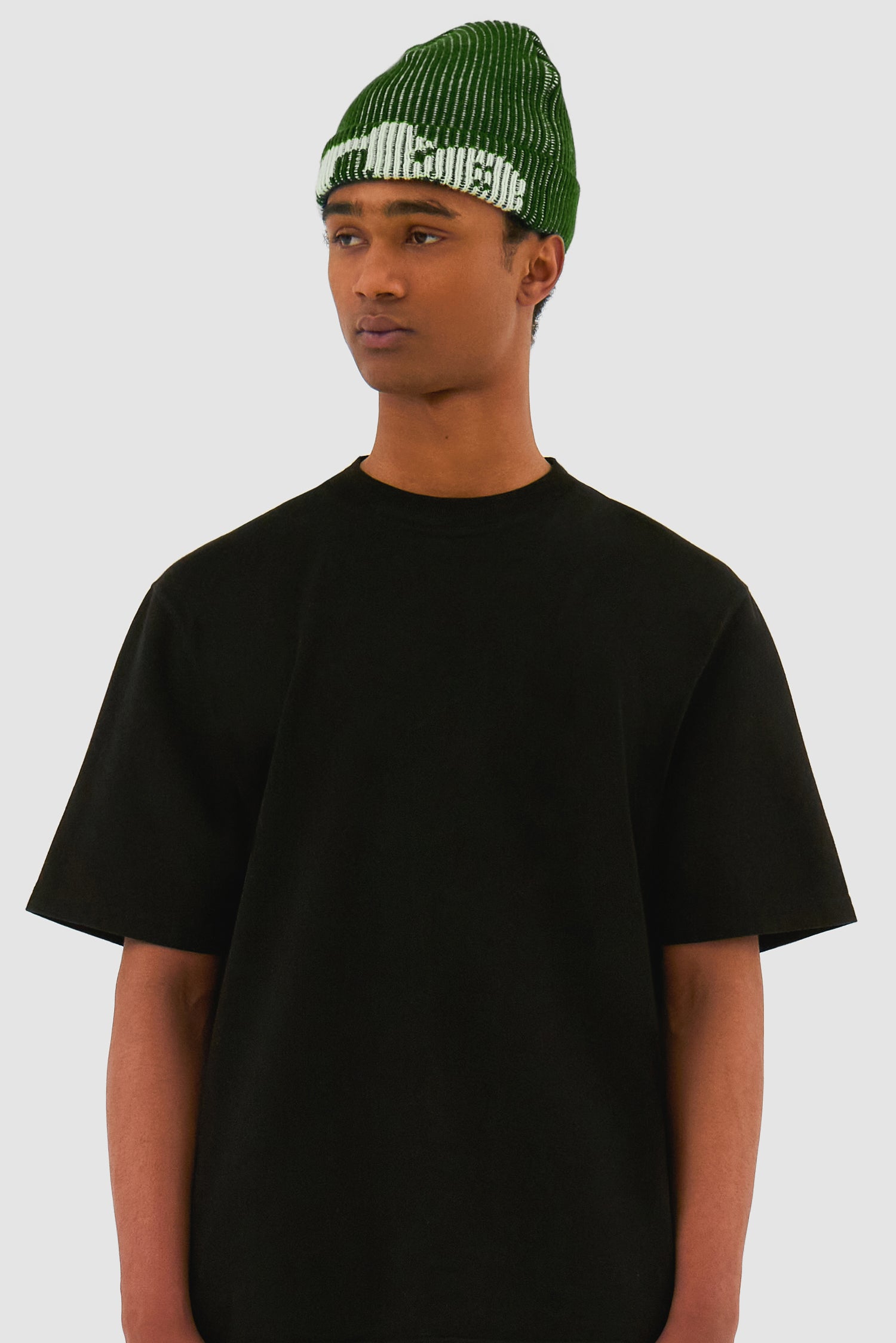 Ribbed Beanie in Green worn by a model, half-body front view