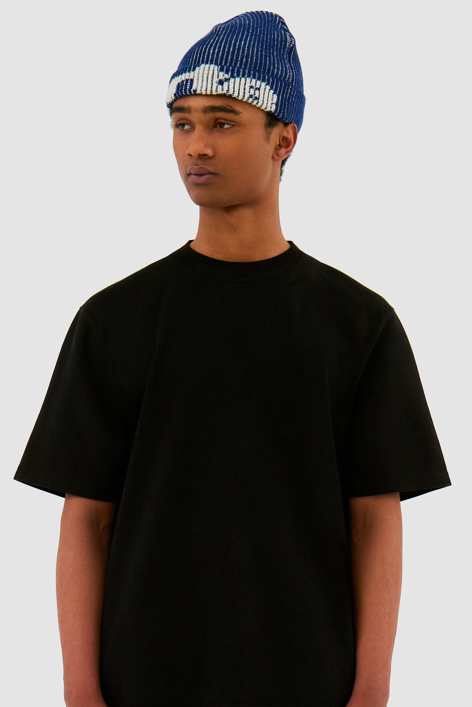 Ribbed Beanie in Navy worn by a model, half-body front view