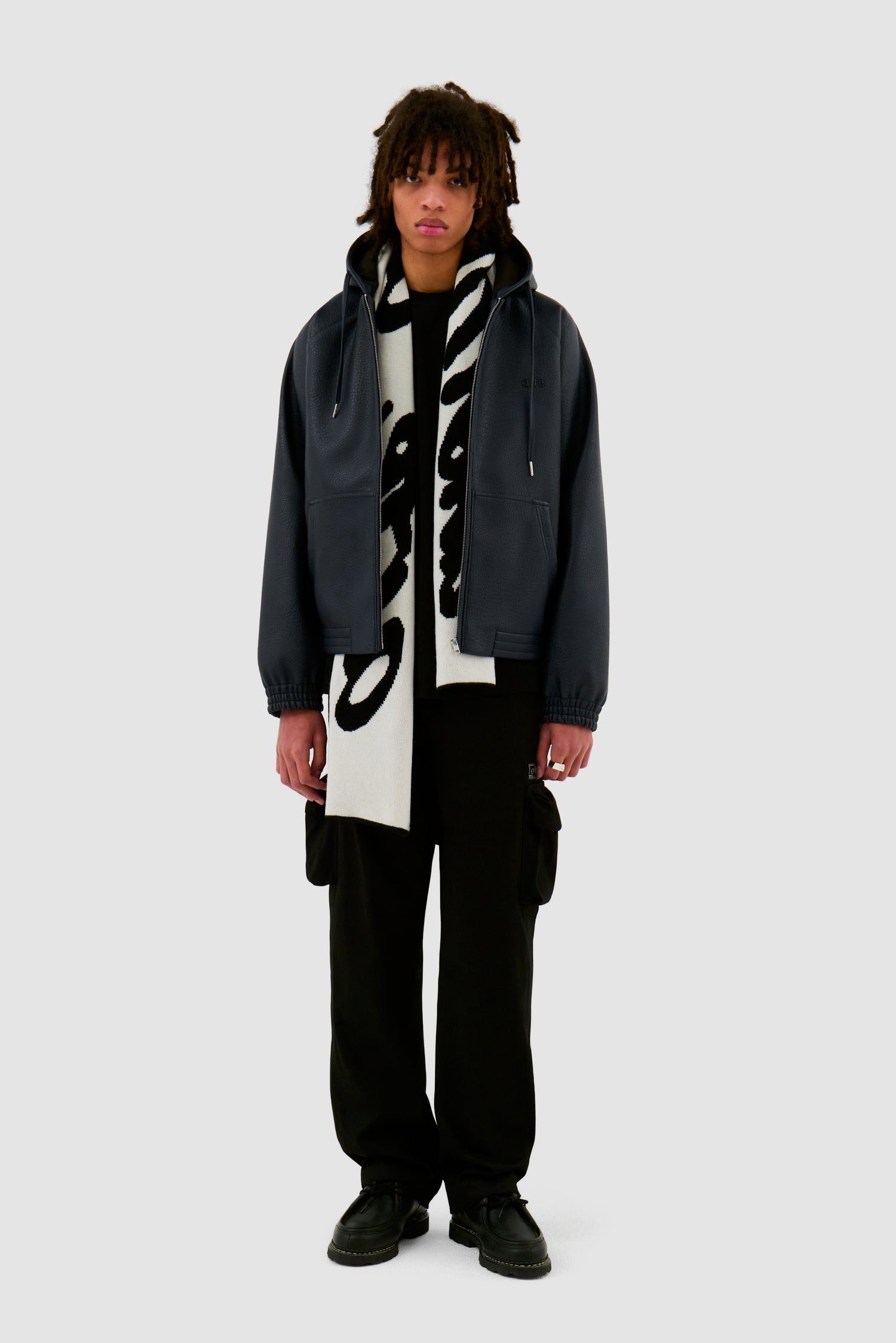 Antwerp Scarf in Black worn by a model, full-body front view