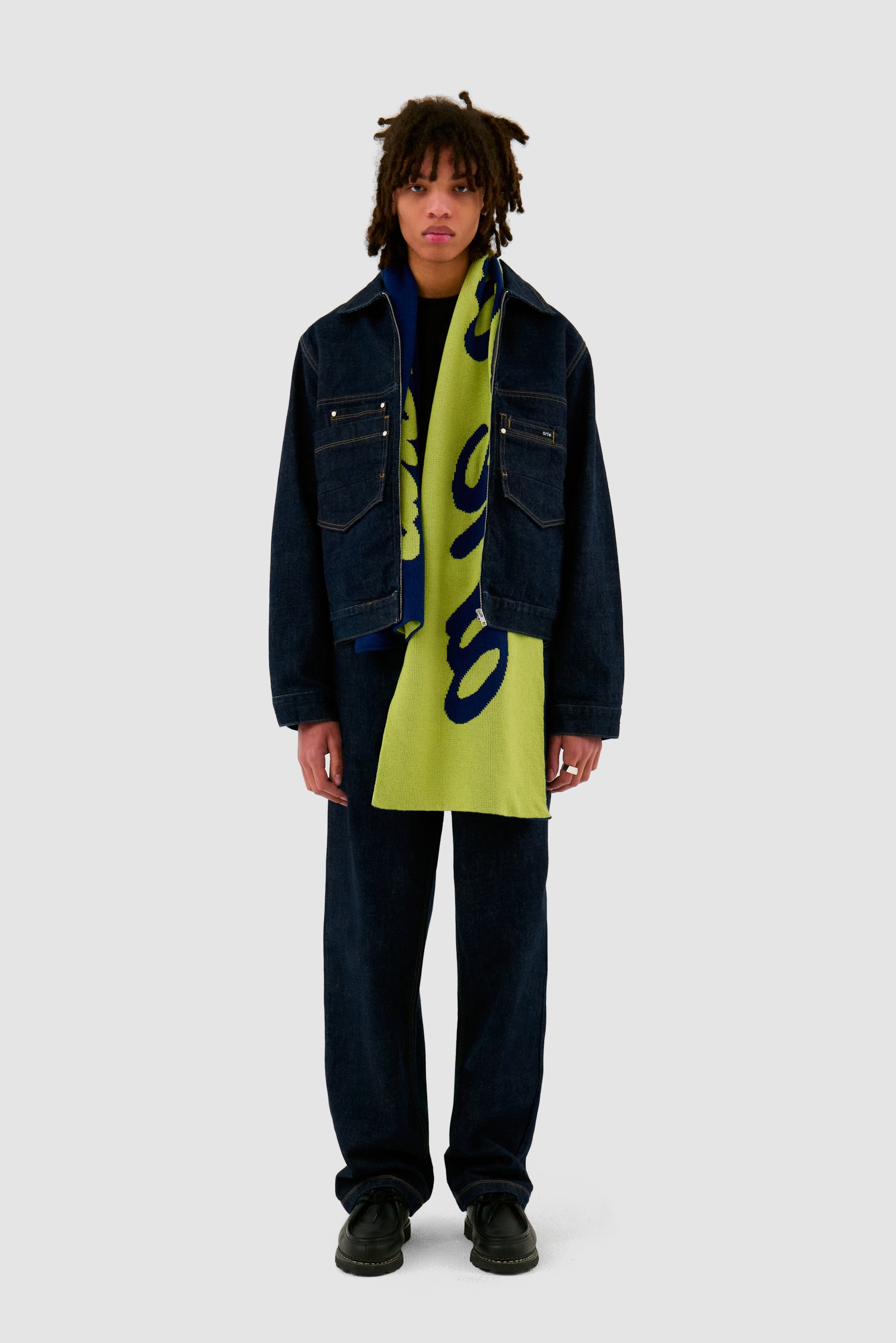 Antwerp Scarf in Navy/Green worn by a model, full-body front view