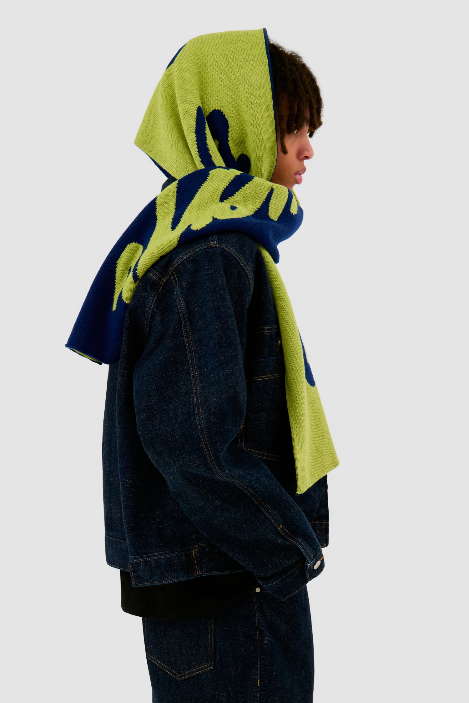 Antwerp Scarf in Navy/Green worn by a model, half-body side view