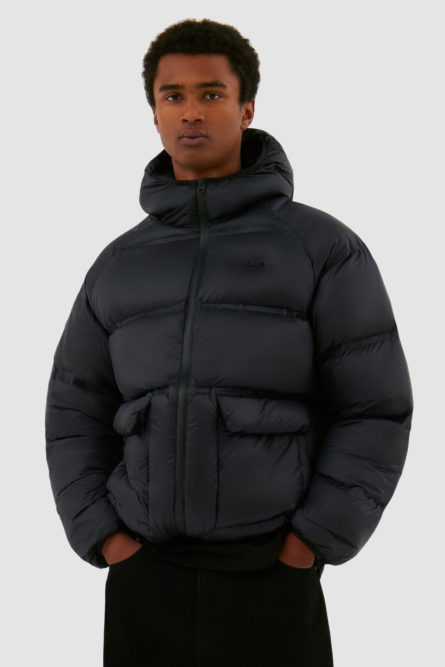 Crop Puffer Jacket in Black worn by a model, half-body front view