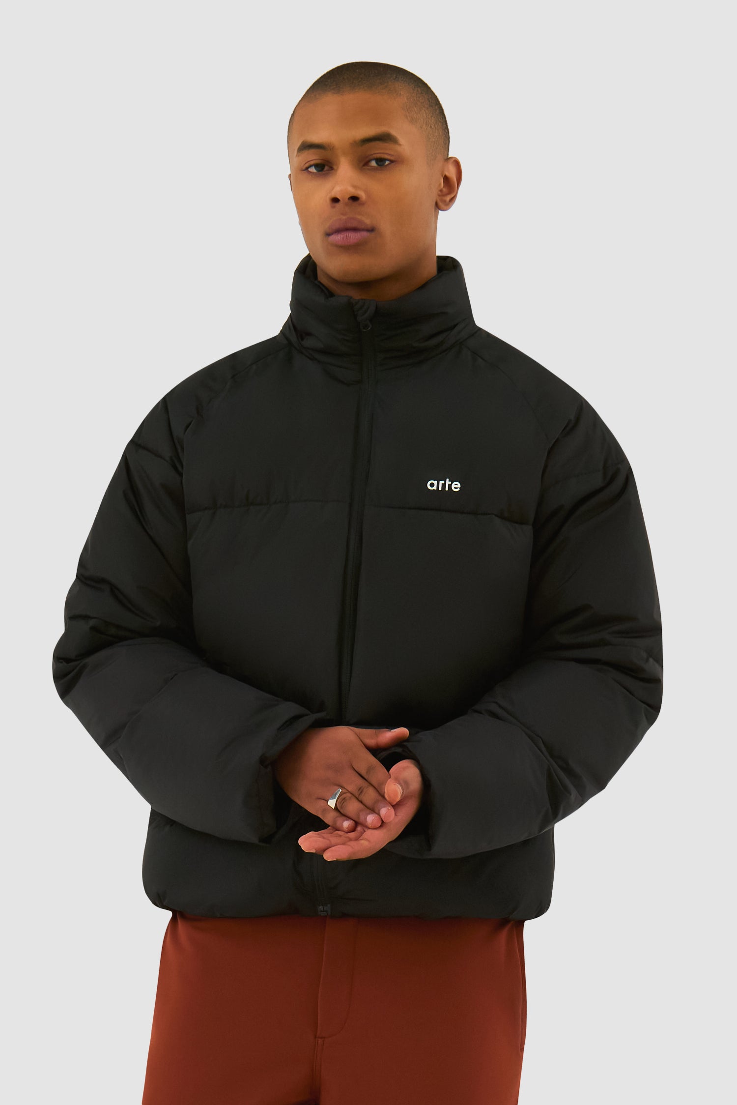 Puffer Jacket in Black worn by a model, half-body front view