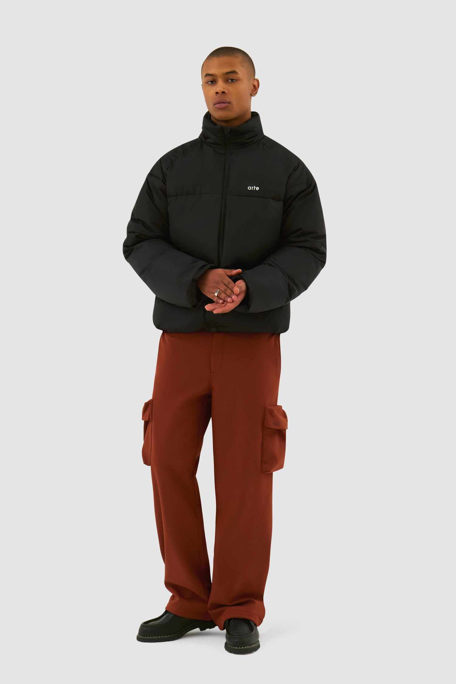 Puffer Jacket in Black worn by a model, full-body front view