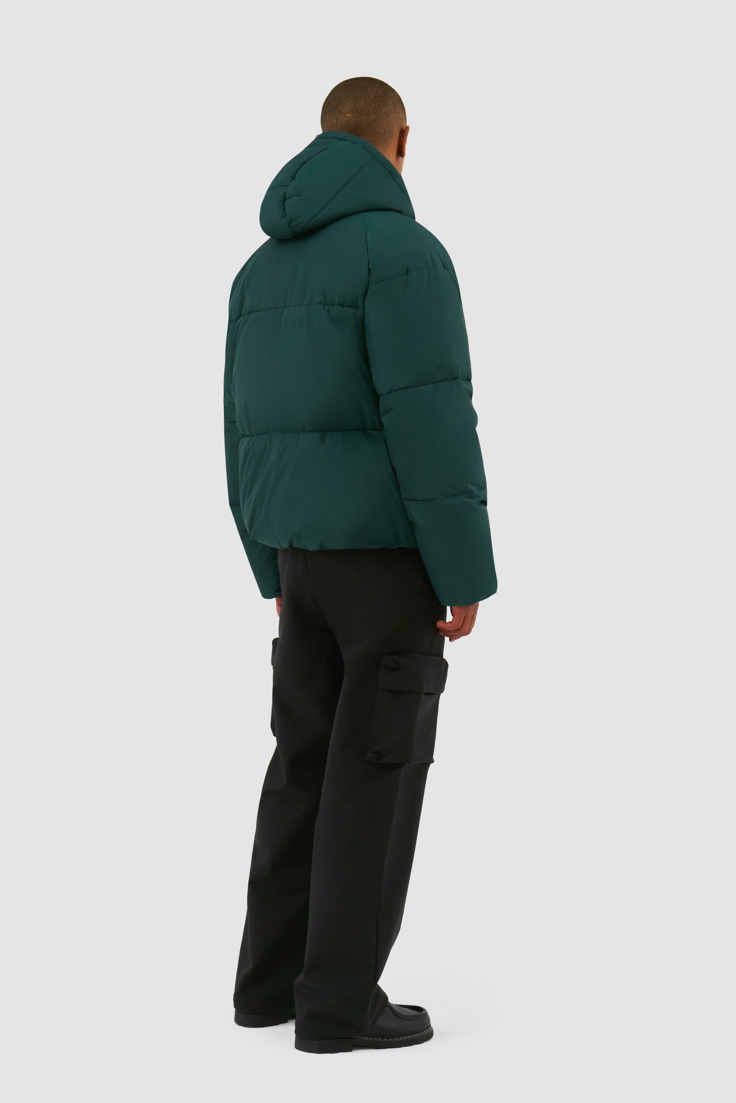 Puffer Jacket in Green worn by a model, full-body back view