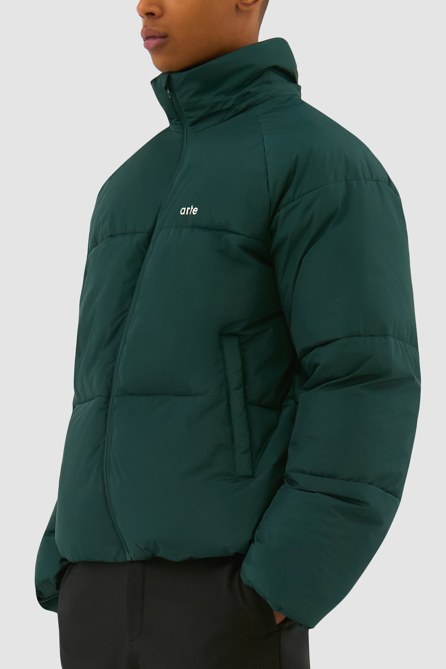 Puffer Jacket in Green worn by a model, half-body detailed view