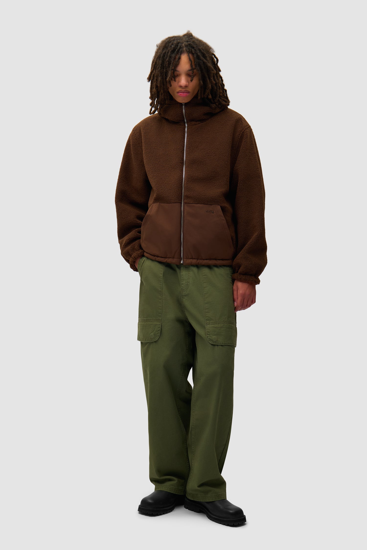 Veste technique en nylon de couleur marron portée par un mannequin, vue de face sur tout le corps