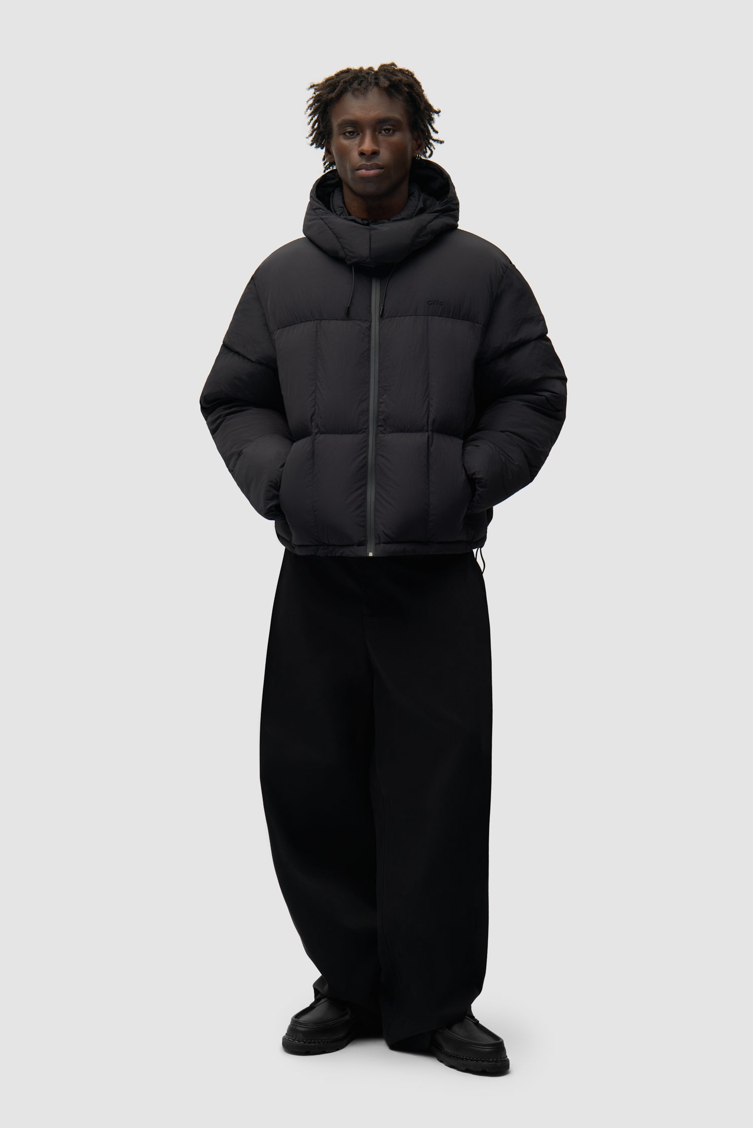 Special Cuts Puffer Jacket in Black worn by a model, full-body front