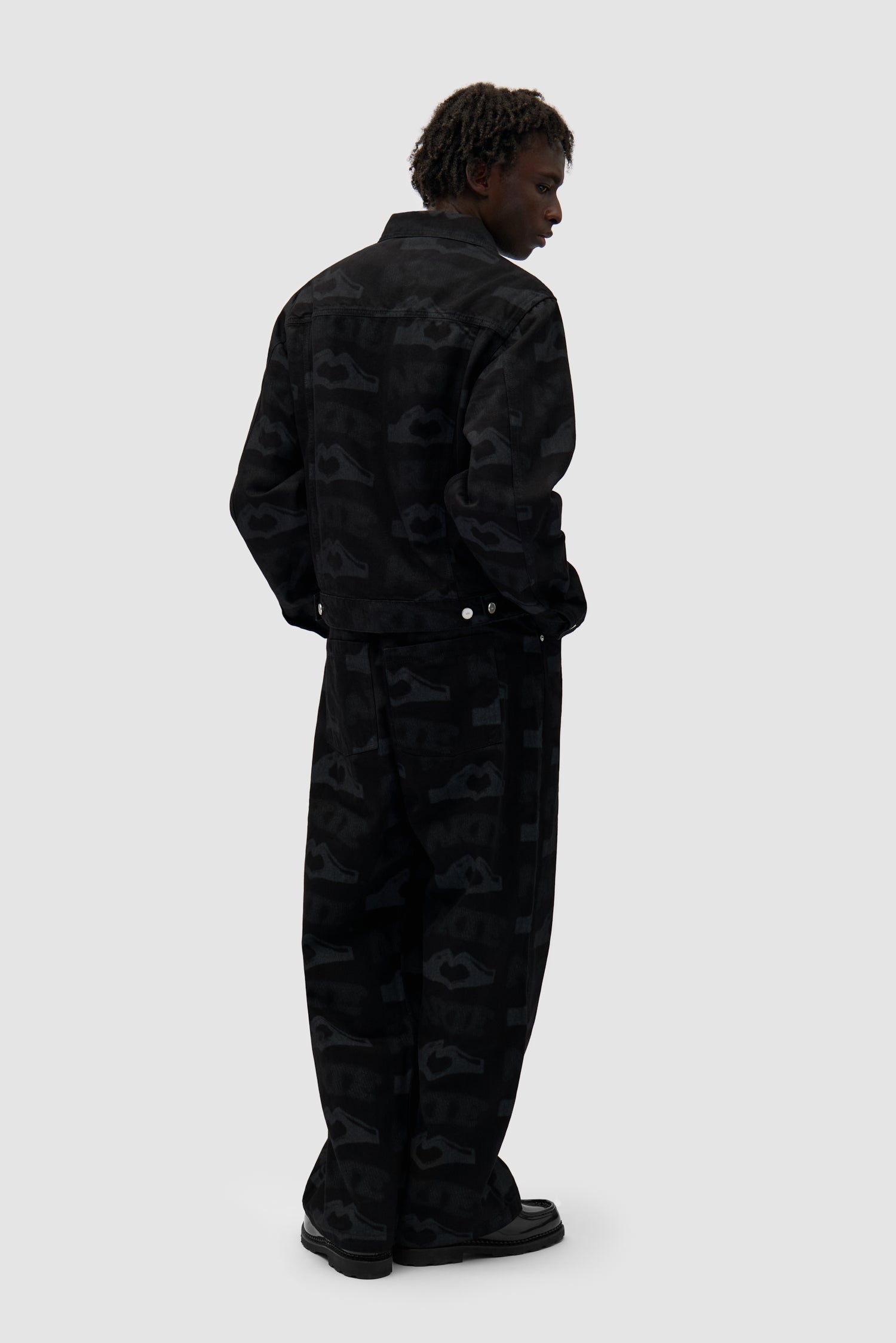 Heart Printed Jacket in Black worn by a model, full-body back view