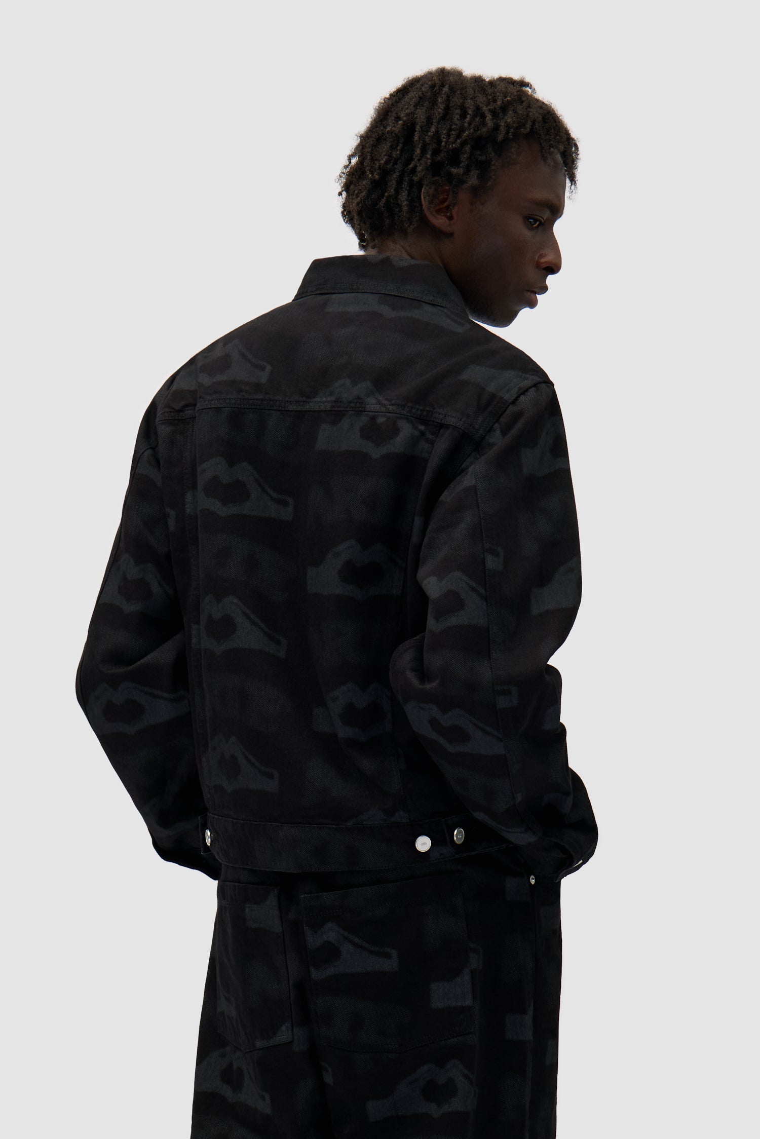 Heart Printed Jacket in Black worn by a model, half-body back view