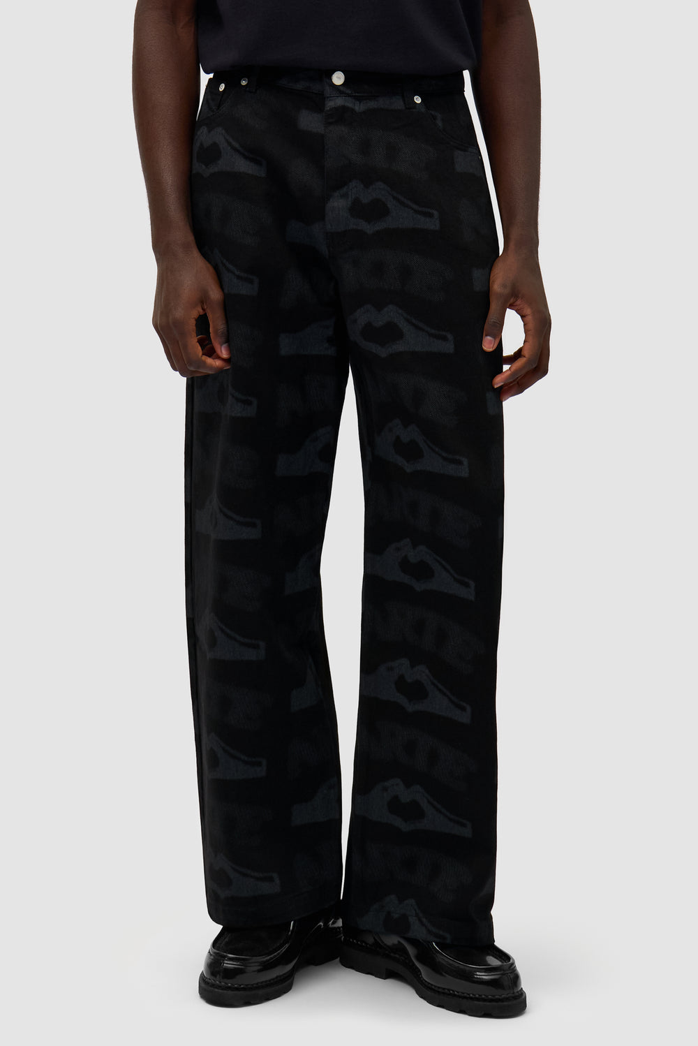Heart Printed Pants in Black worn by a model, half-body front view