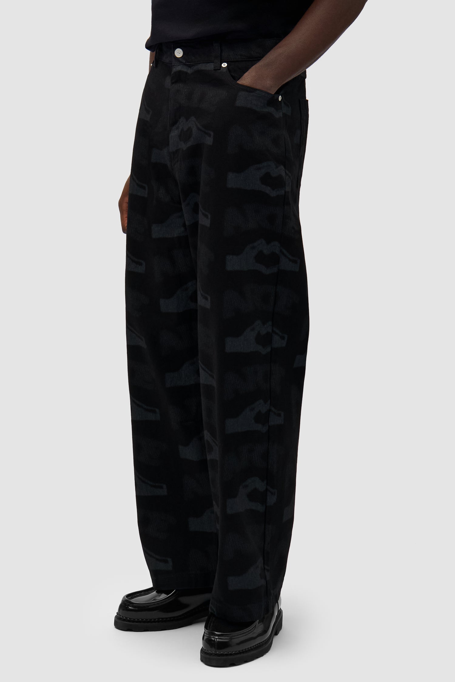 Heart Printed Pants in Black worn by a model, half-body side view