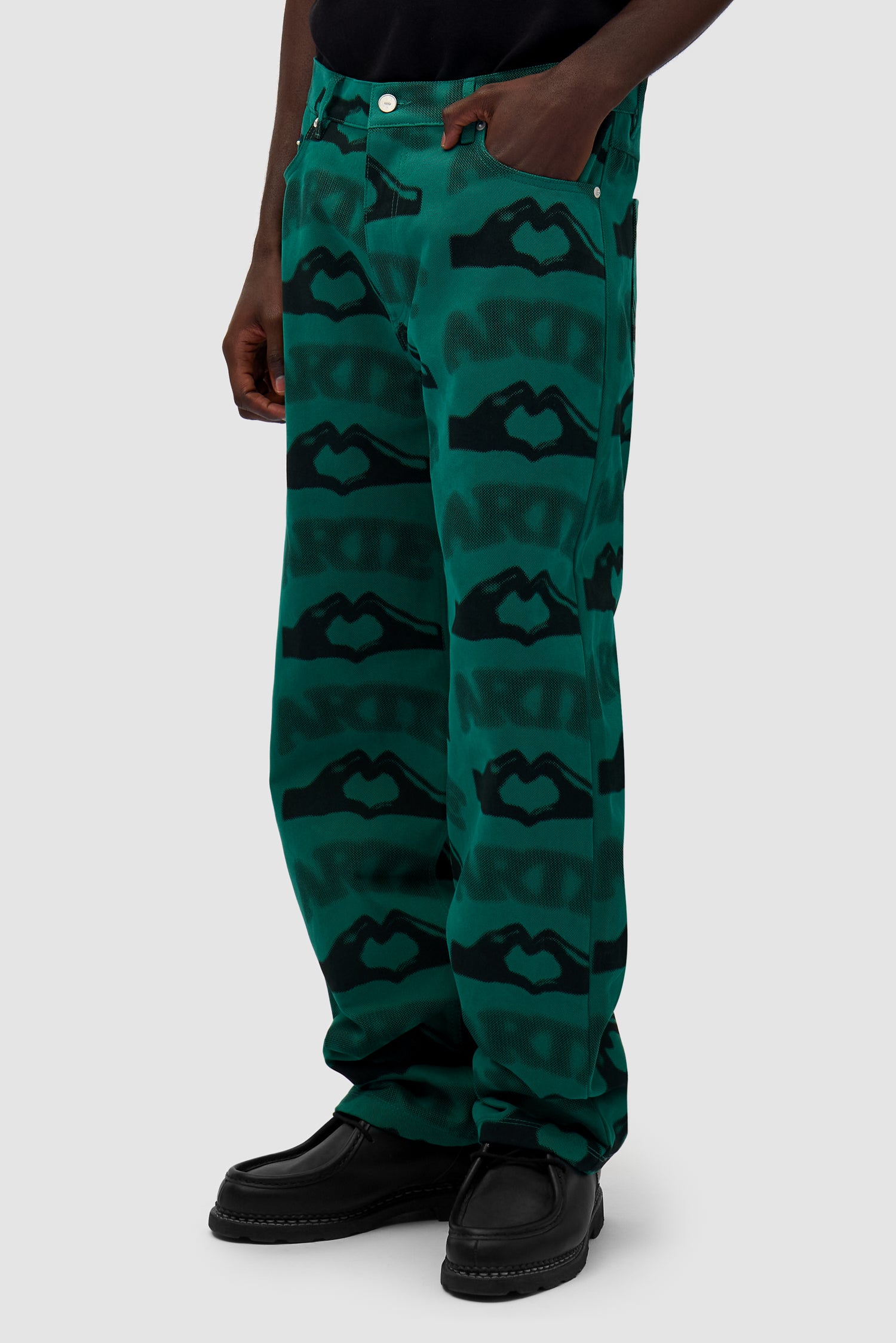 Heart Printed Pants in Green worn by a model, half-body side view