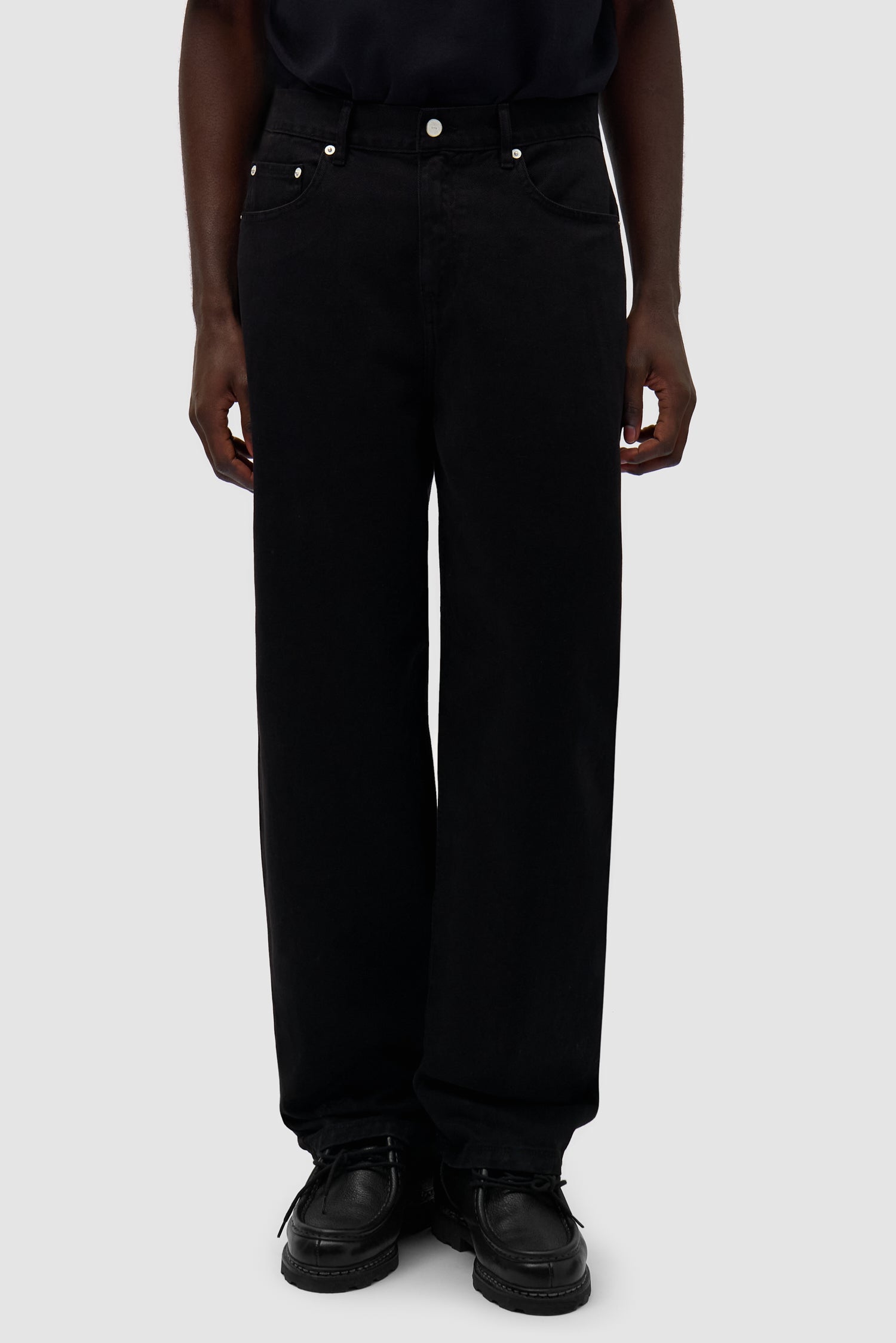 Back Bird Pants in Black worn by a model, half-body side view