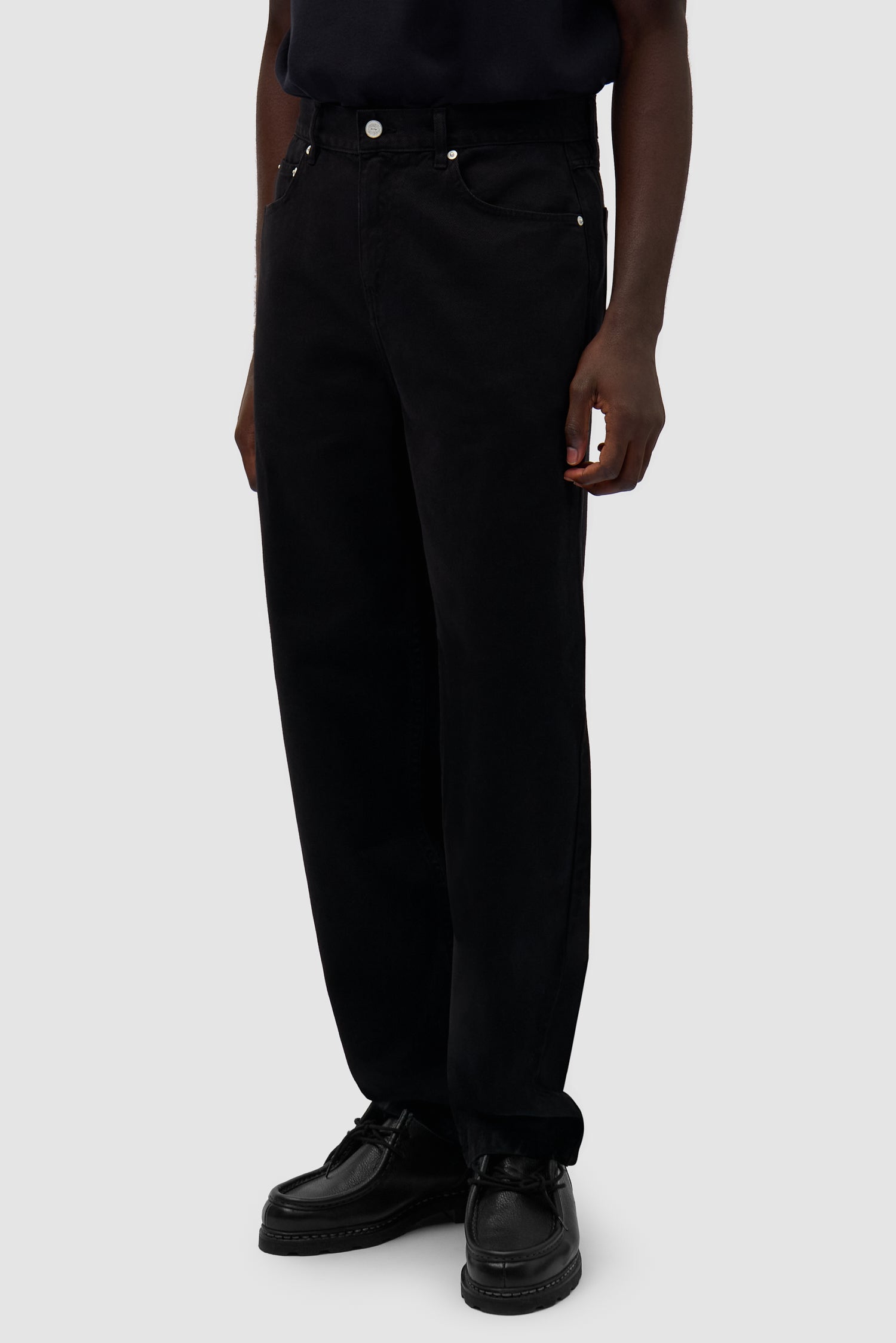 Back Bird Pants in Black worn by a model, half-body back view