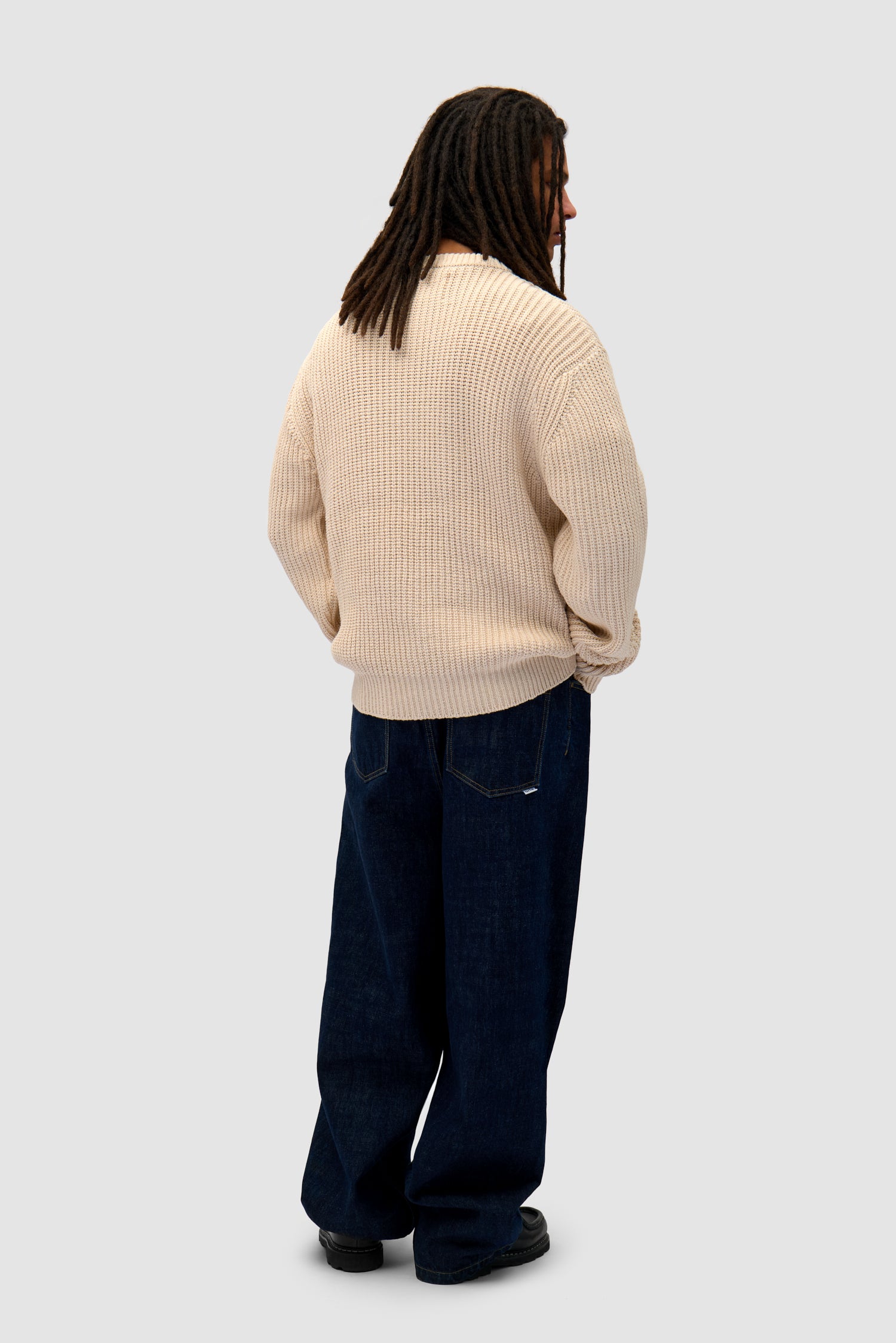 Cross Stitch Knit in Cream worn by a model, full-body back view