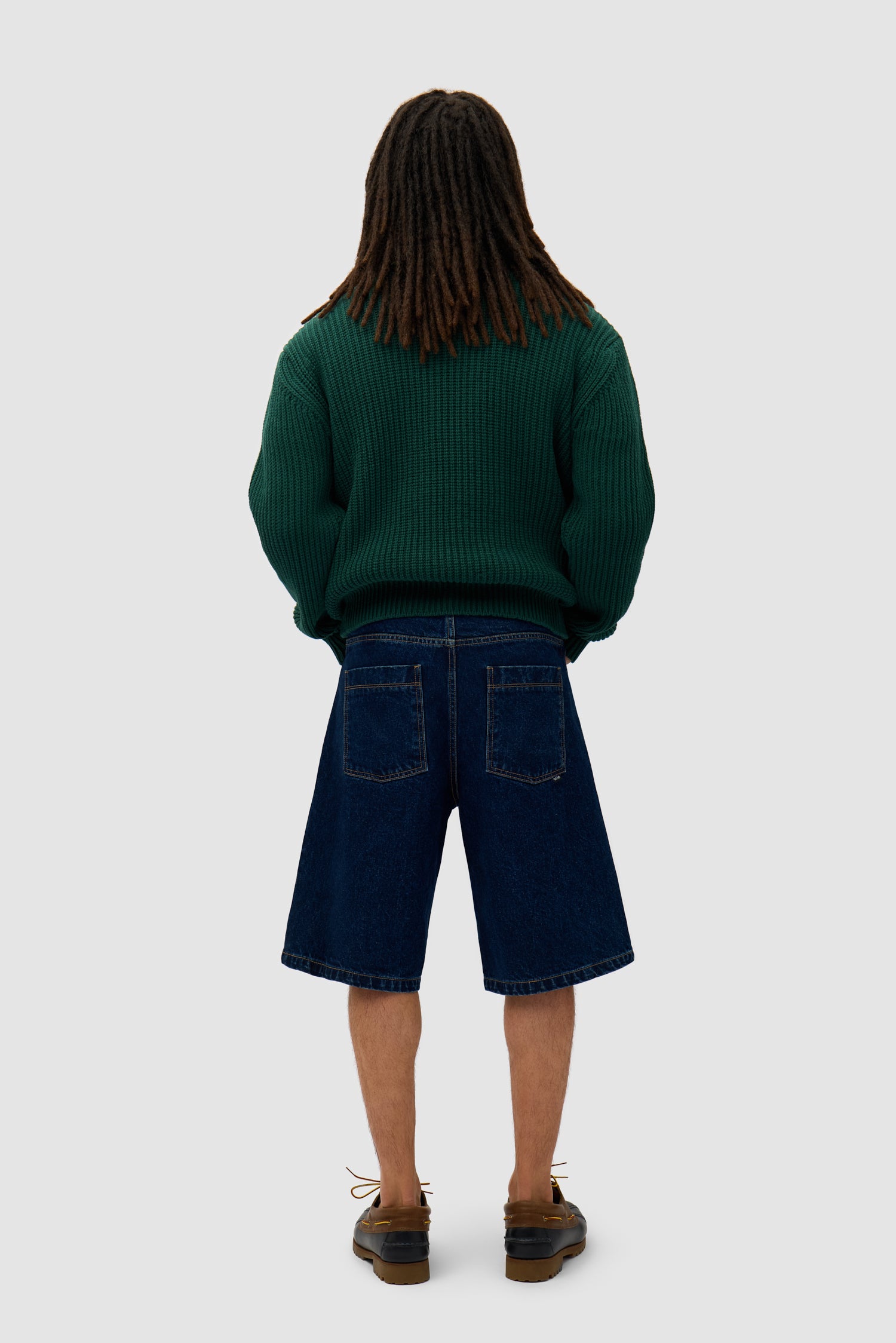 Cross Stitch Knit in Green worn by a model, full-body back view