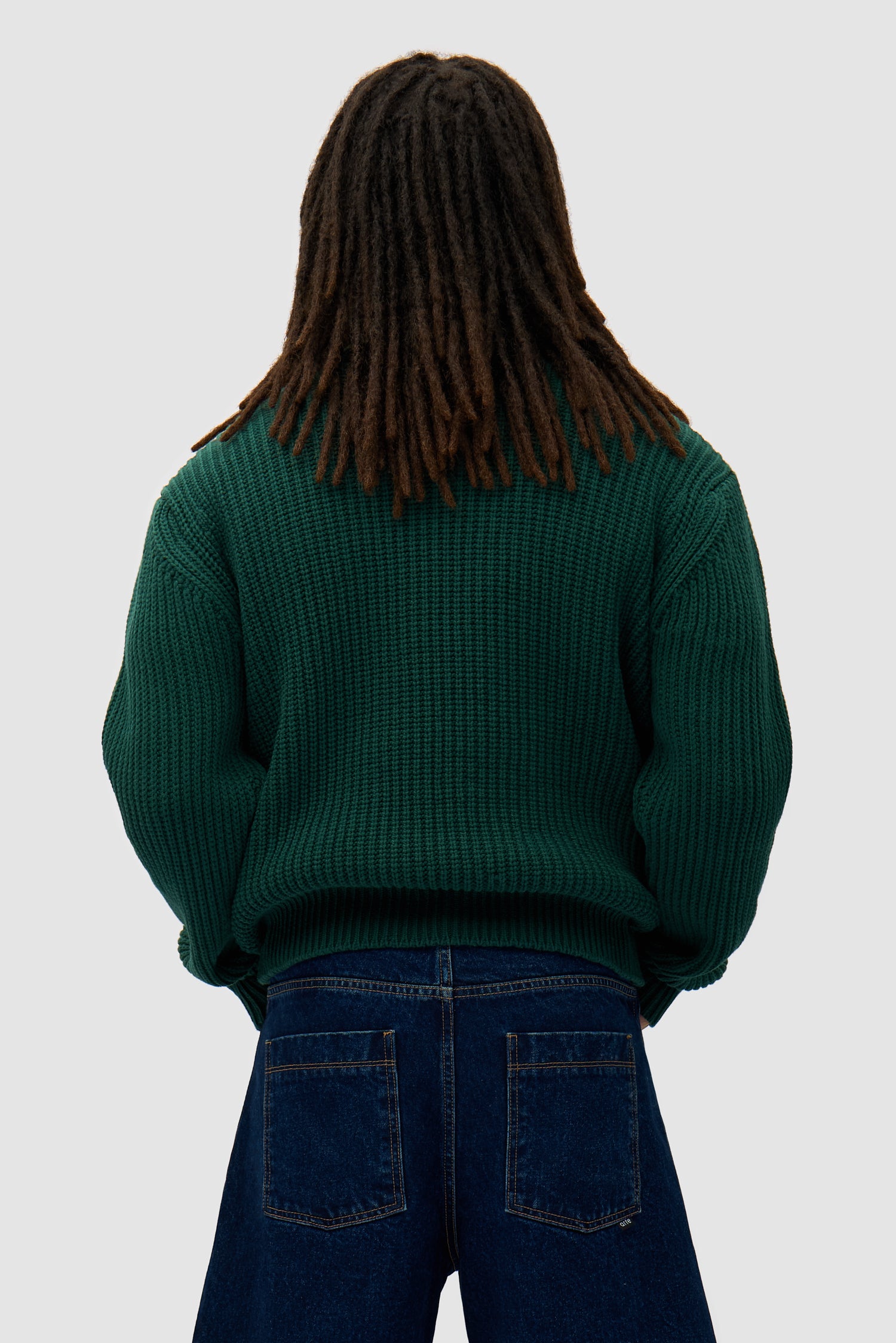 Cross Stitch Knit in Green worn by a model, half-body back view