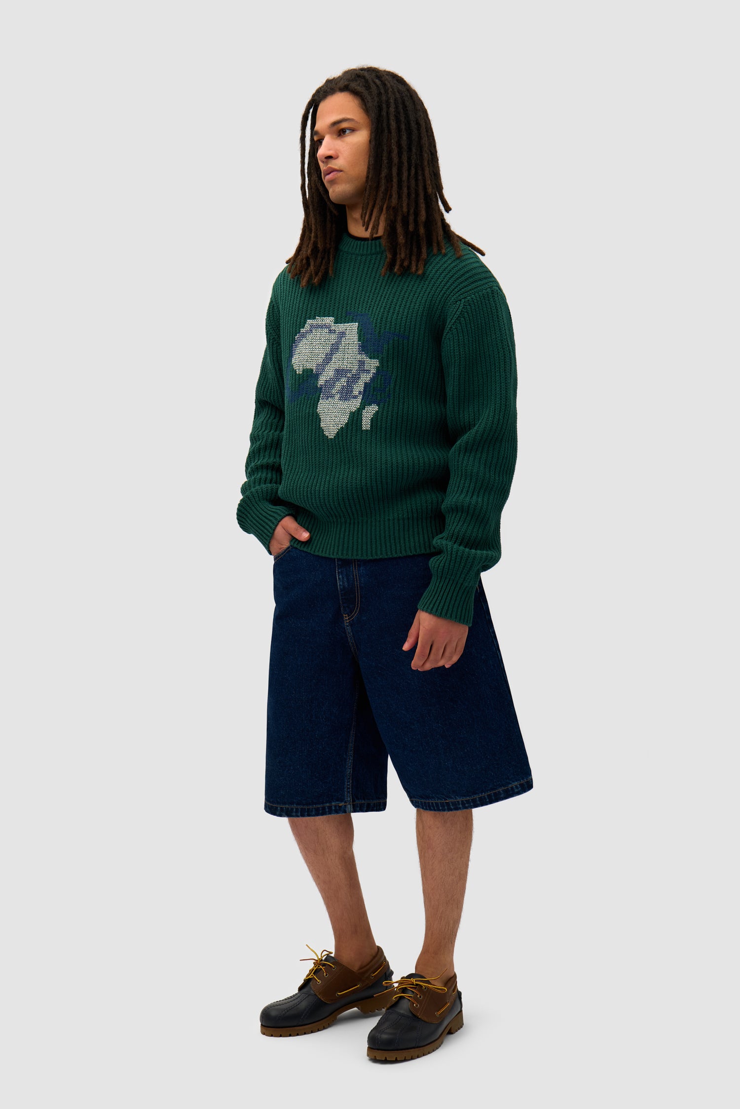 Cross Stitch Knit in Green worn by a model, full-body side view