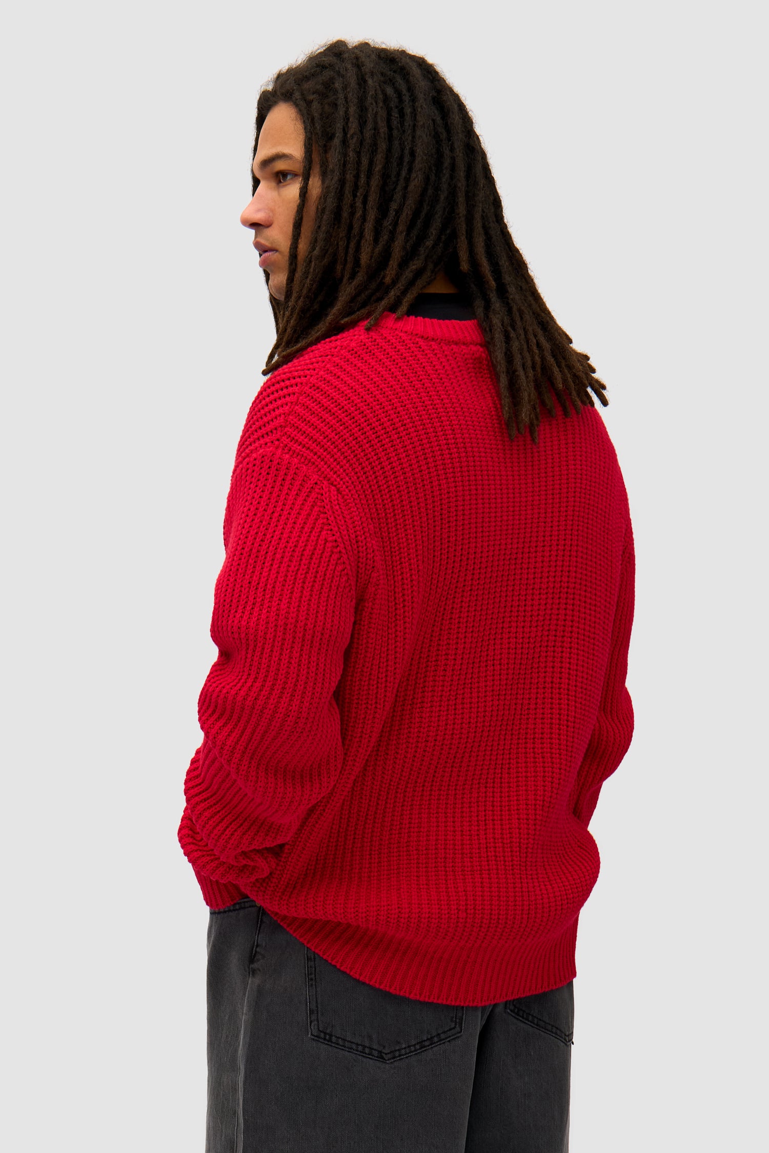Cross Stitch Knit in Red worn by a model, half-body back view