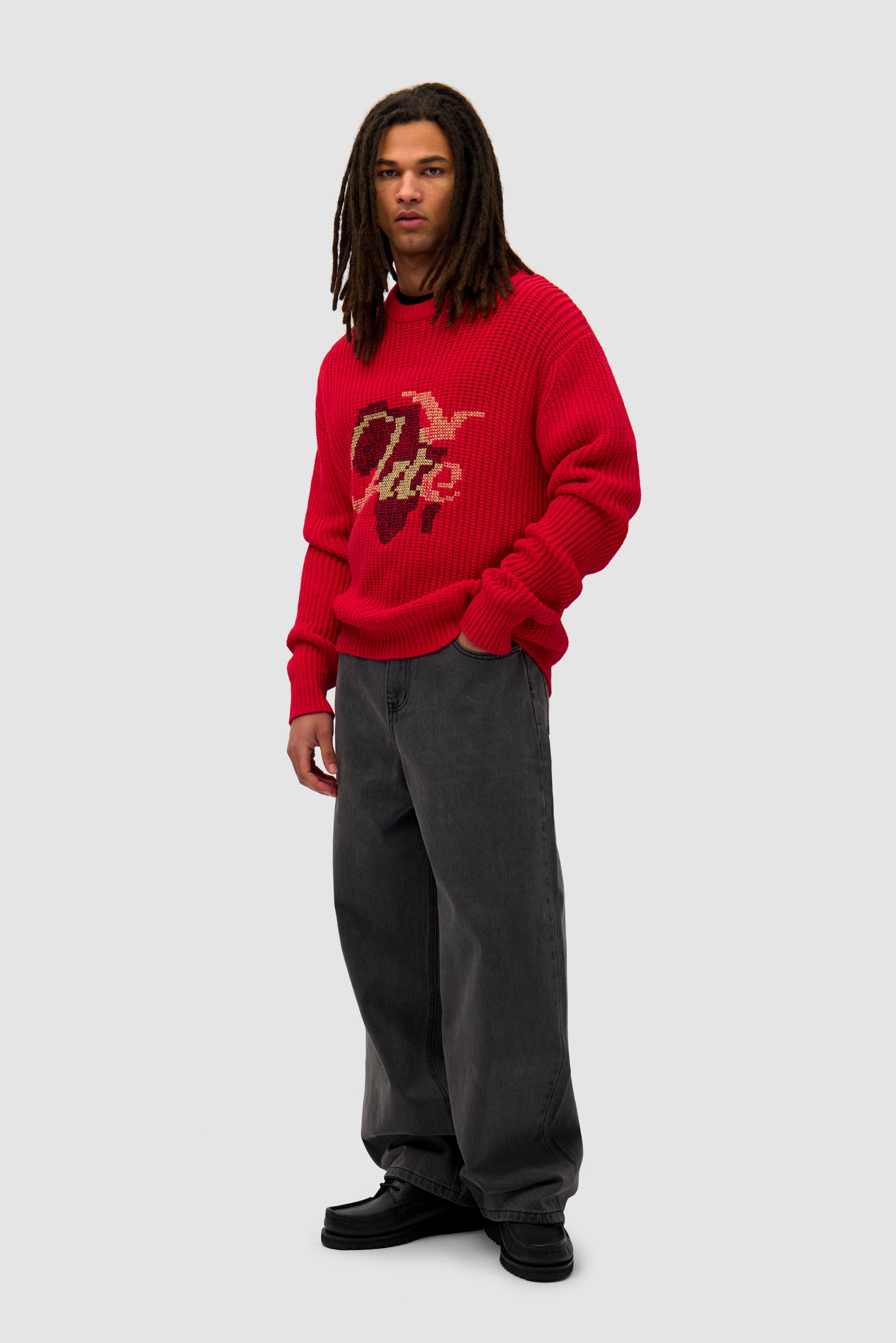 Cross Stitch Knit in Red worn by a model, full-body side view
