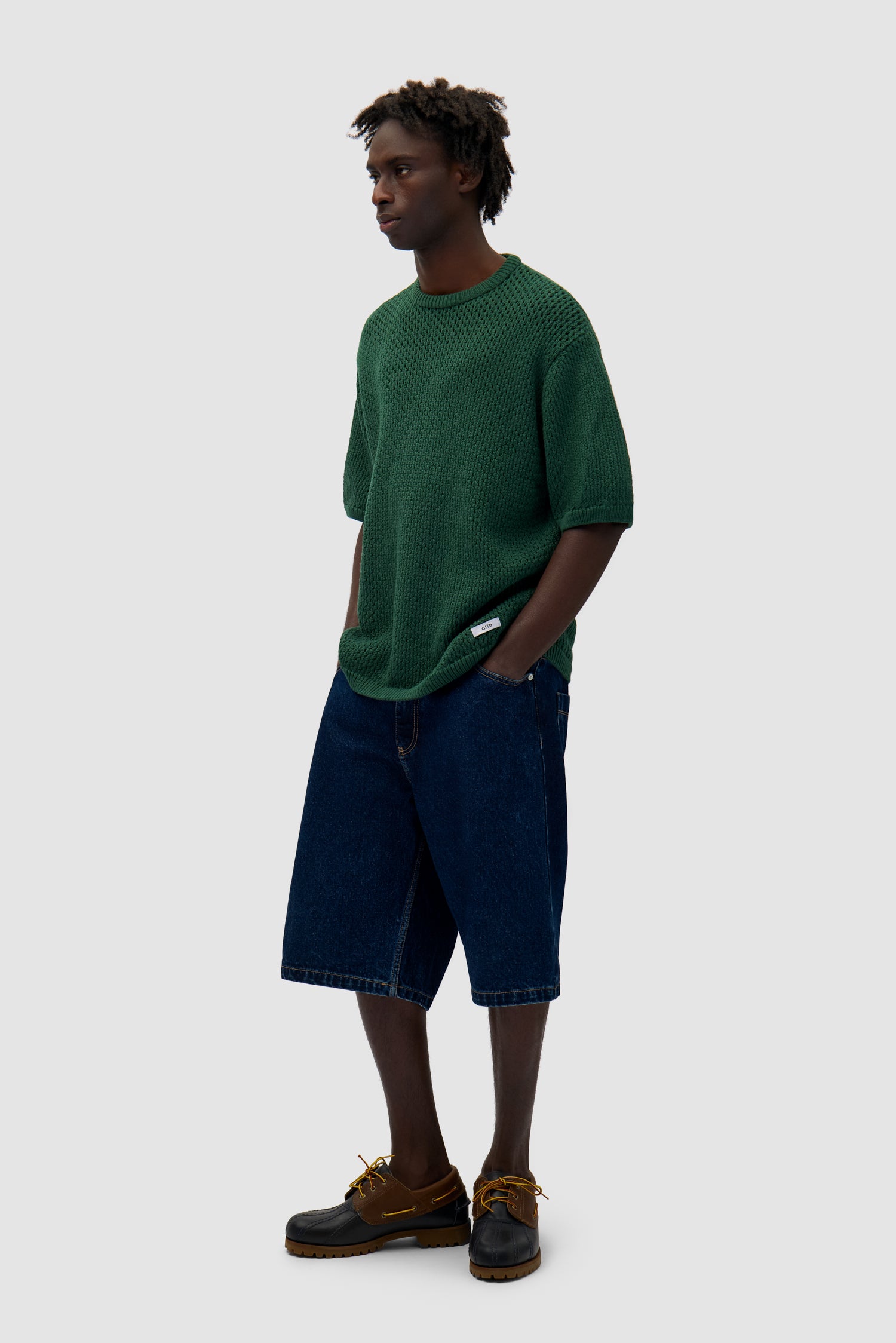 Crochet Knit T-shirt in Green worn by a model, full-body side view