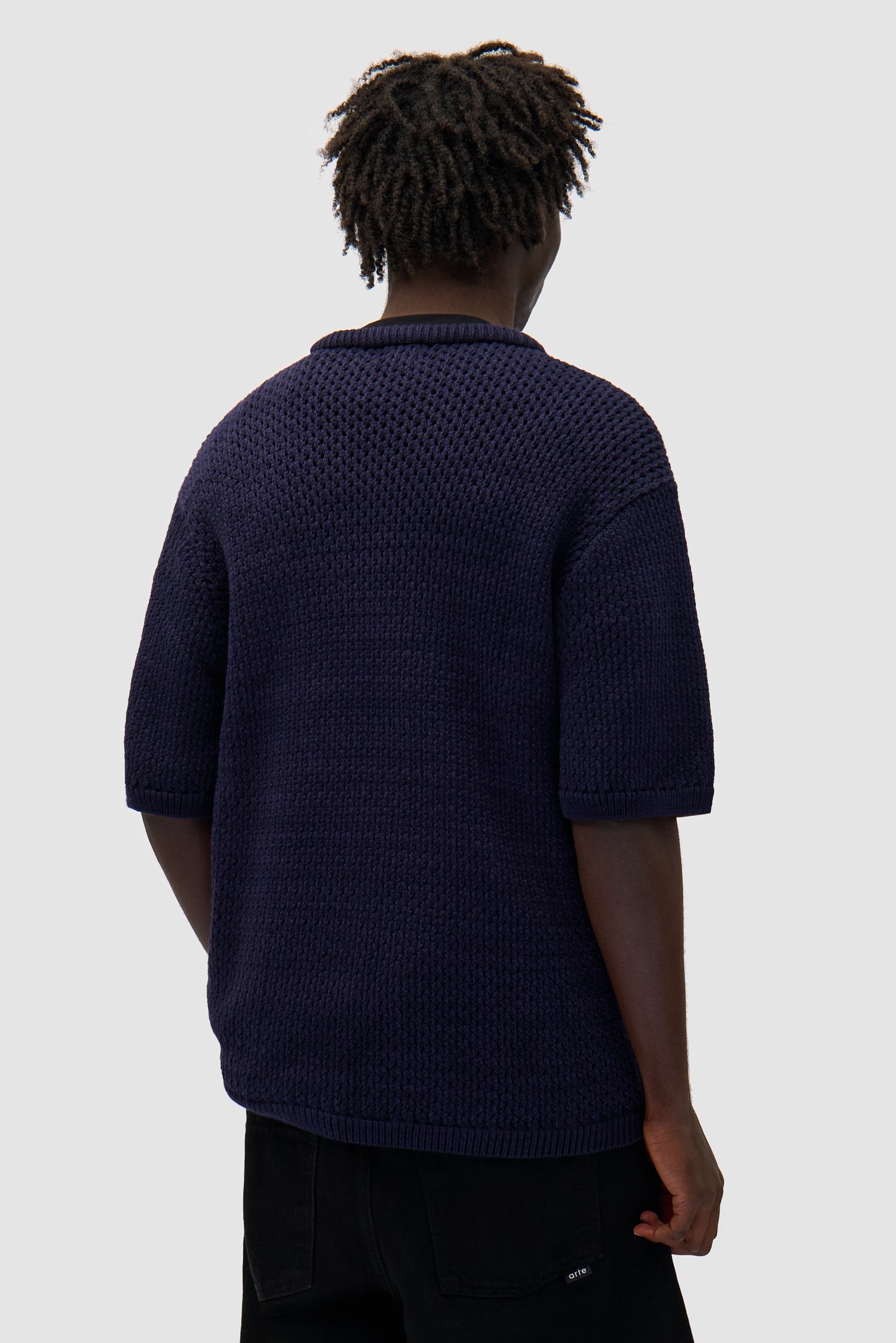 Crochet Knit T-shirt in Navy worn by a model, half-body back view
