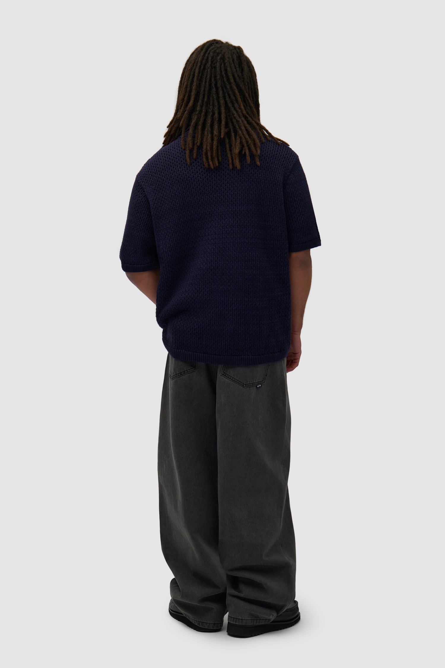 Crochet Knit Button Shirt in Navy worn by a model, full-body back view