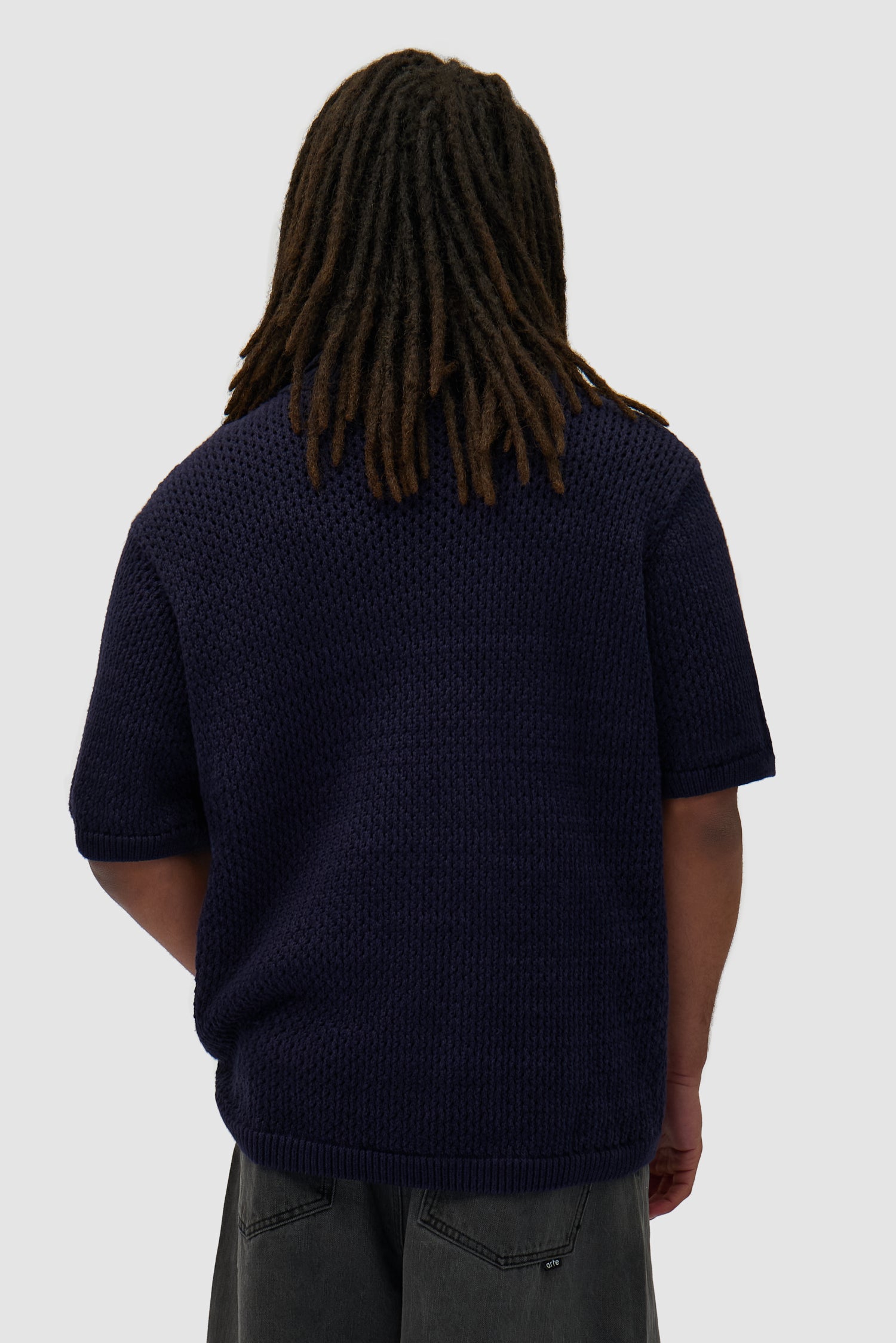Crochet Knit Button Shirt in Navy worn by a model, half-body back view