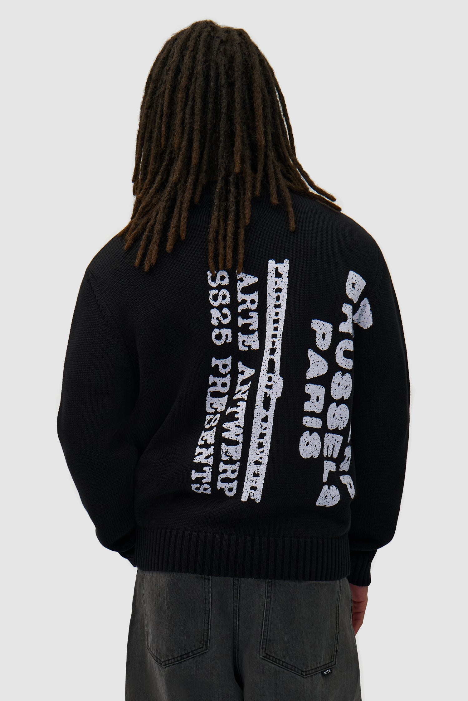 Big Print Knit Sweater in Black worn by a model, half-body back view