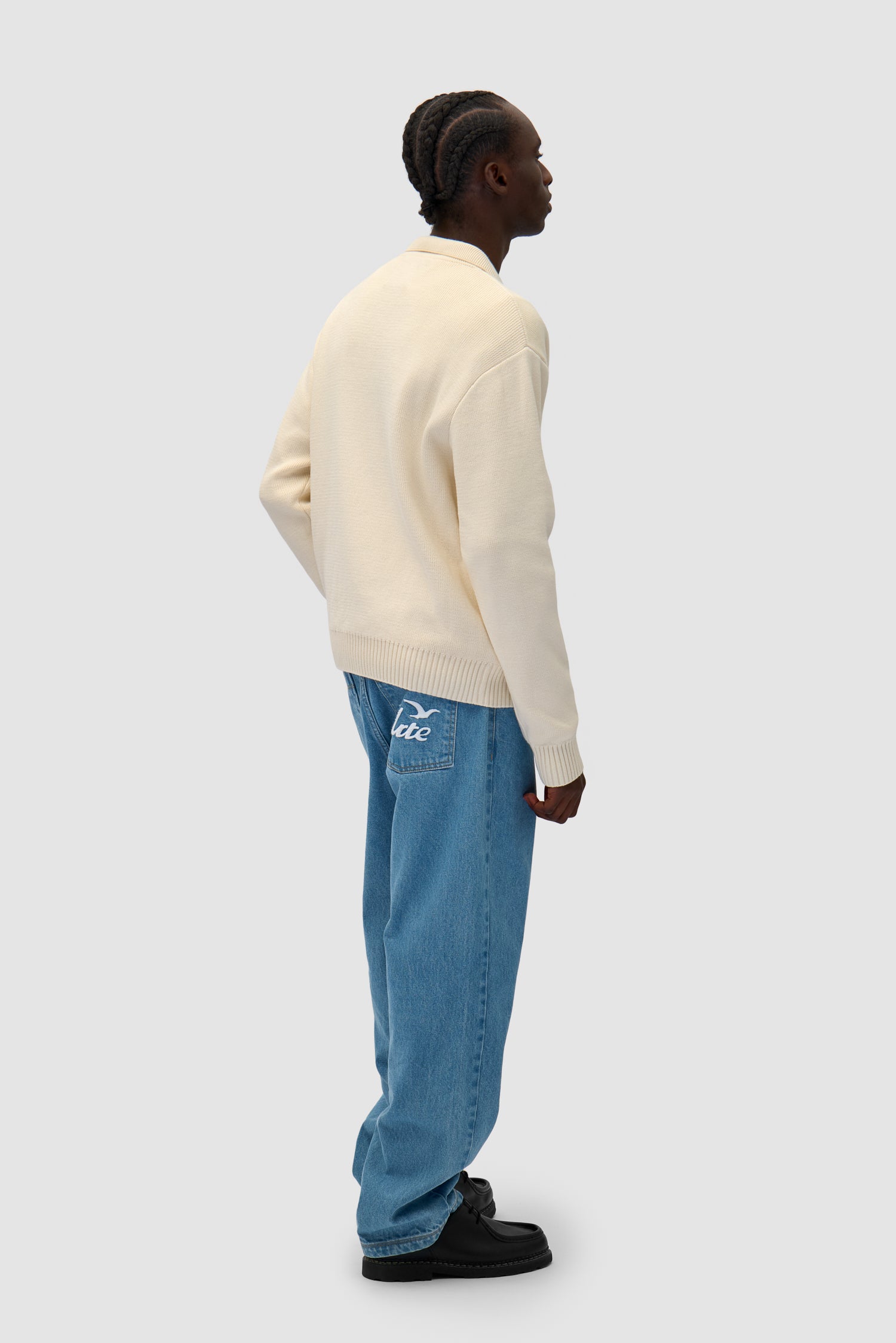 Bird Logo Knit in Cream worn by a model, full-body back view