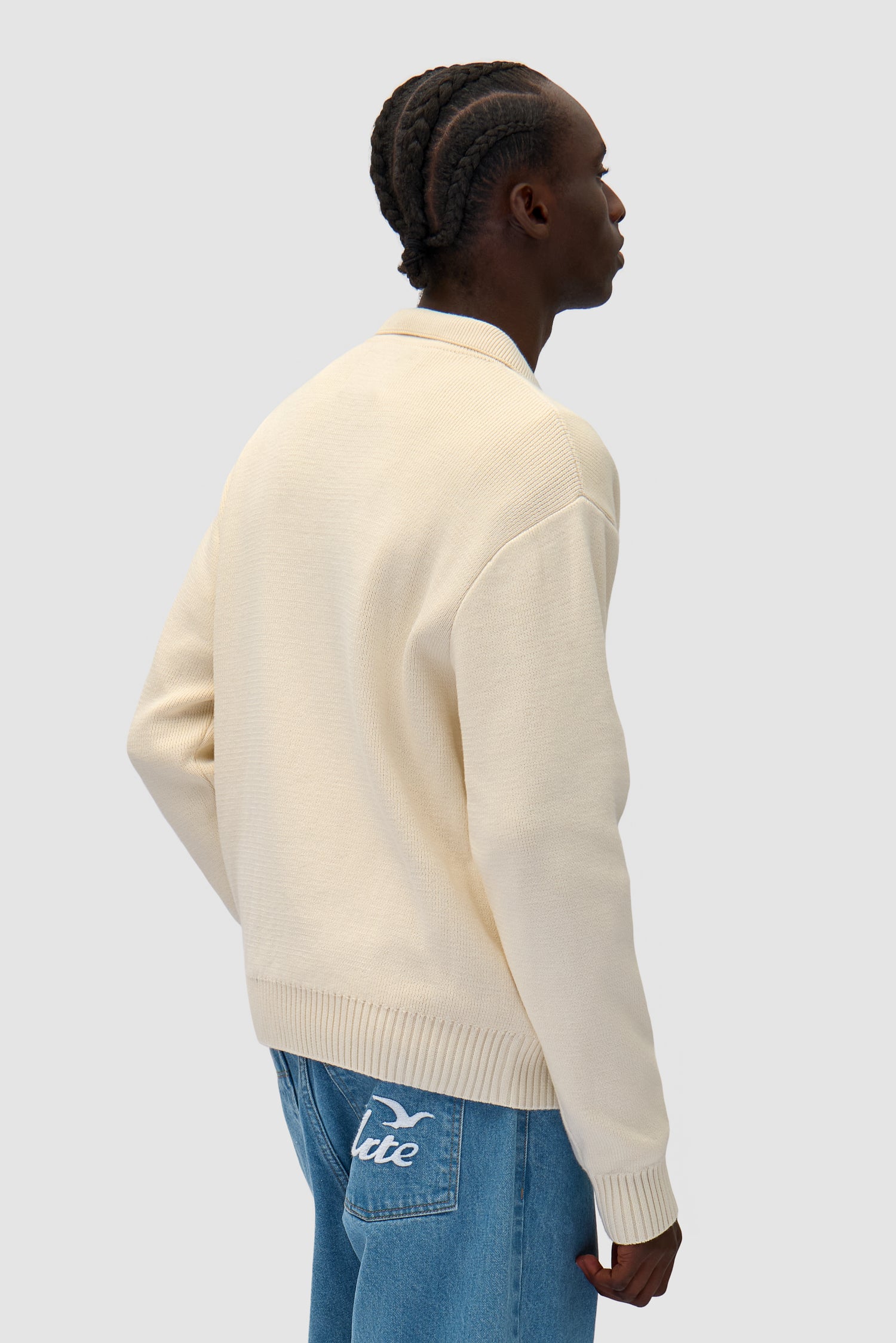 Bird Logo Knit in Cream worn by a model, half-body back view