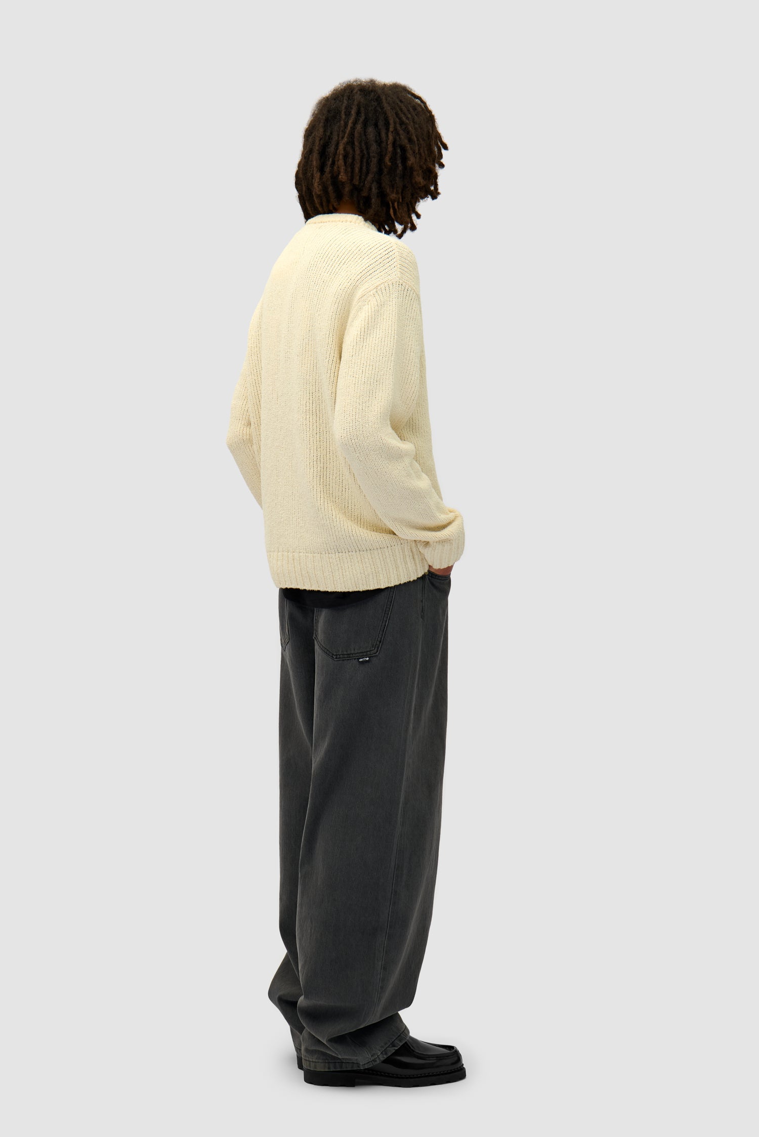 Logo Knit Sweater in Cream worn by a model, full-body back view
